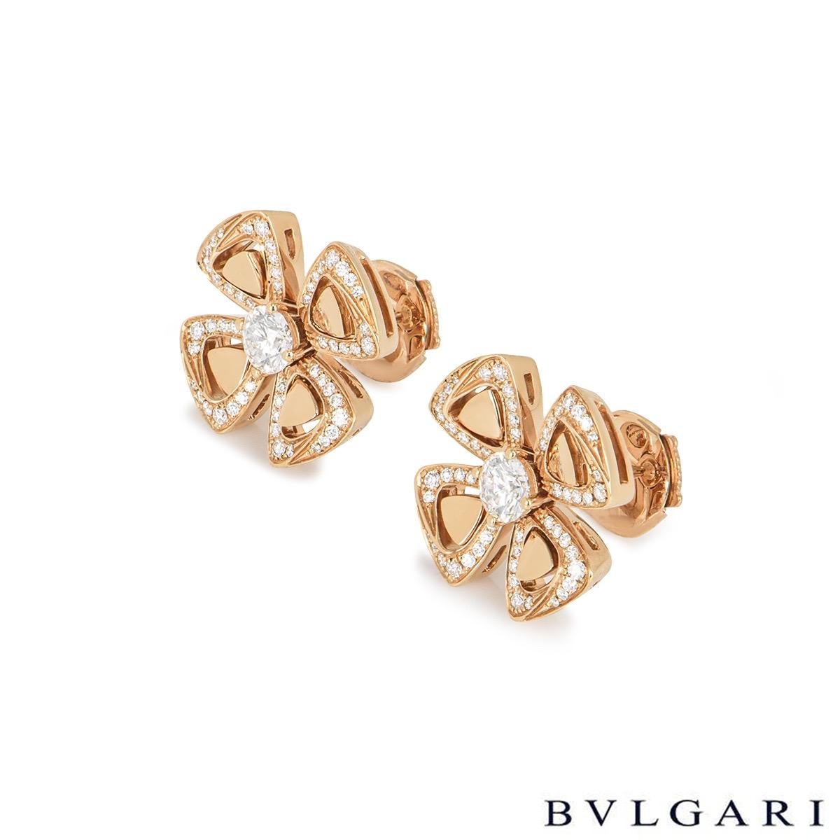 A pair of 18k rose gold Bvlgari earrings from the Fiorever collection. Each earring features a single round brilliant cut diamond surrounded by four openwork flower petals set with pave diamonds. The diamonds have a total weight of approximately