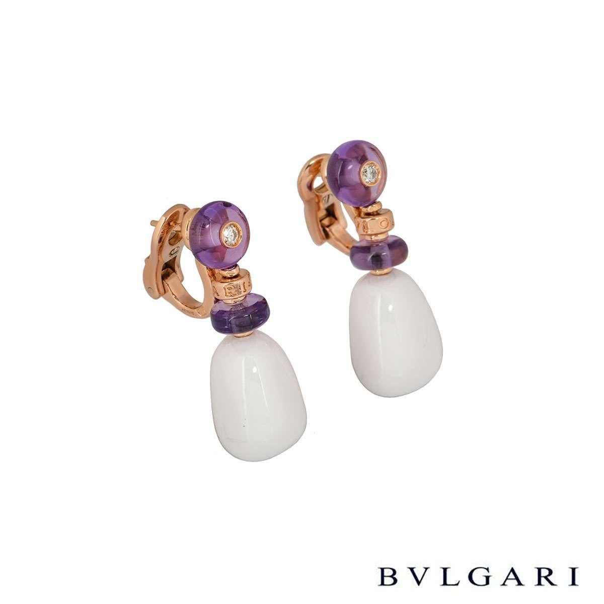 An 18k pair of 18k rose gold earrings by Bvlgari from the Mediterranean Eden collection. The earrings each comprise of 2 amethyst beads with a round brilliant cut diamonds in the centre of one and a white ceramic bead suspended beneath it. The