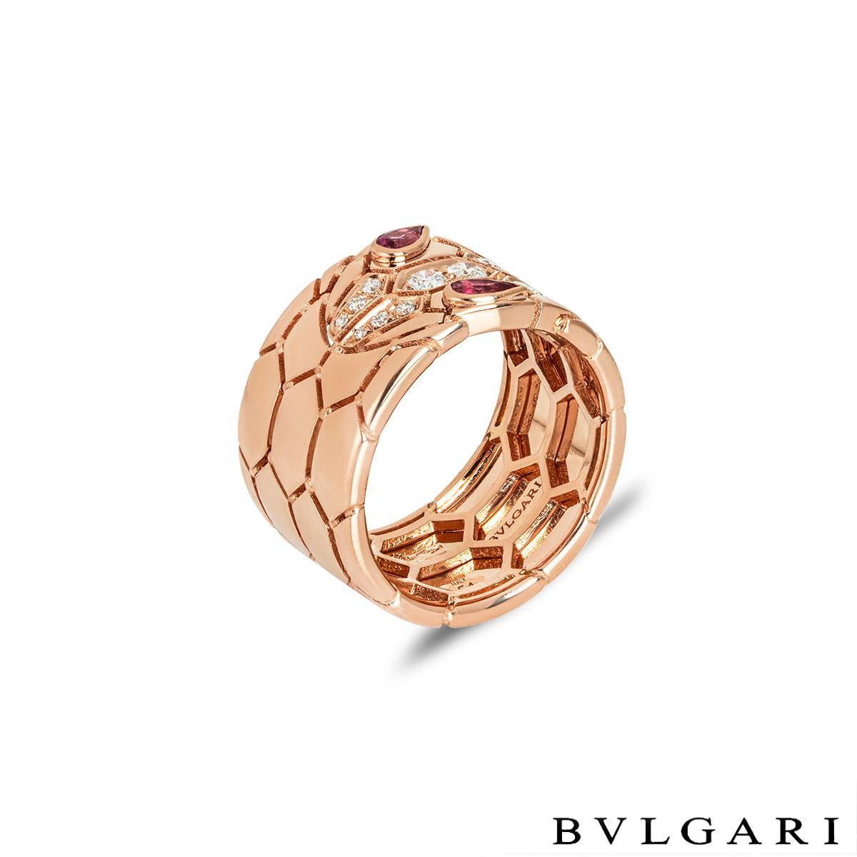 An entrancing 18k rose gold diamond and rubellite ring by Bvlgari from the Serpenti Seduttori collection. The ring is composed of a snake design throughout with a diamond set head and rubellite eyes. The 12 round brilliant cut diamonds have an