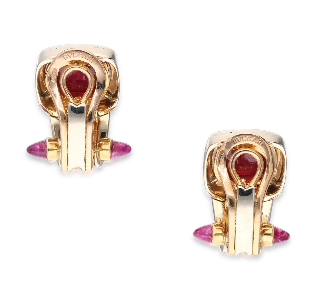 Bvlgari 18 karat yellow gold pair of ear clips. Each ear clip is set with cabochon rubies, bullet-shaped rubies, and baguette diamonds. The diamonds weigh a total of approximately 1 carat. Marked: Bvlgari. Made in Italy. Total weight: 14.47 grams.