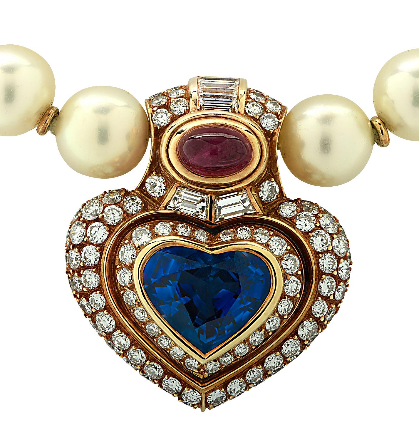 Sensational Bvlgari pearl, sapphire, ruby and diamond necklace circa 1990, crafted in 18 karat yellow gold, showcasing an AGL certified heart shaped blue Ceylon Sapphire weighing approximately 6.83 carats, an oval ruby cabochon weighing