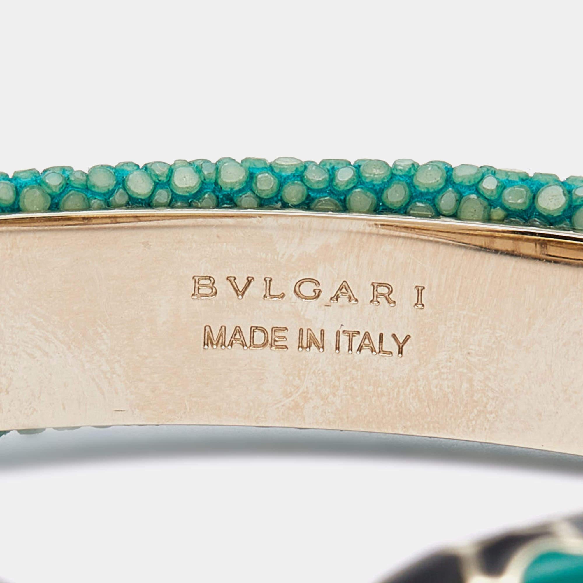 The Bvlgari Serpenti Forever bracelet is a luxurious and elegant accessory. It features a green galuchat leather band with gold-plated accents, showcasing the iconic Serpenti snake motif. This exquisite cuff bracelet exudes sophistication and
