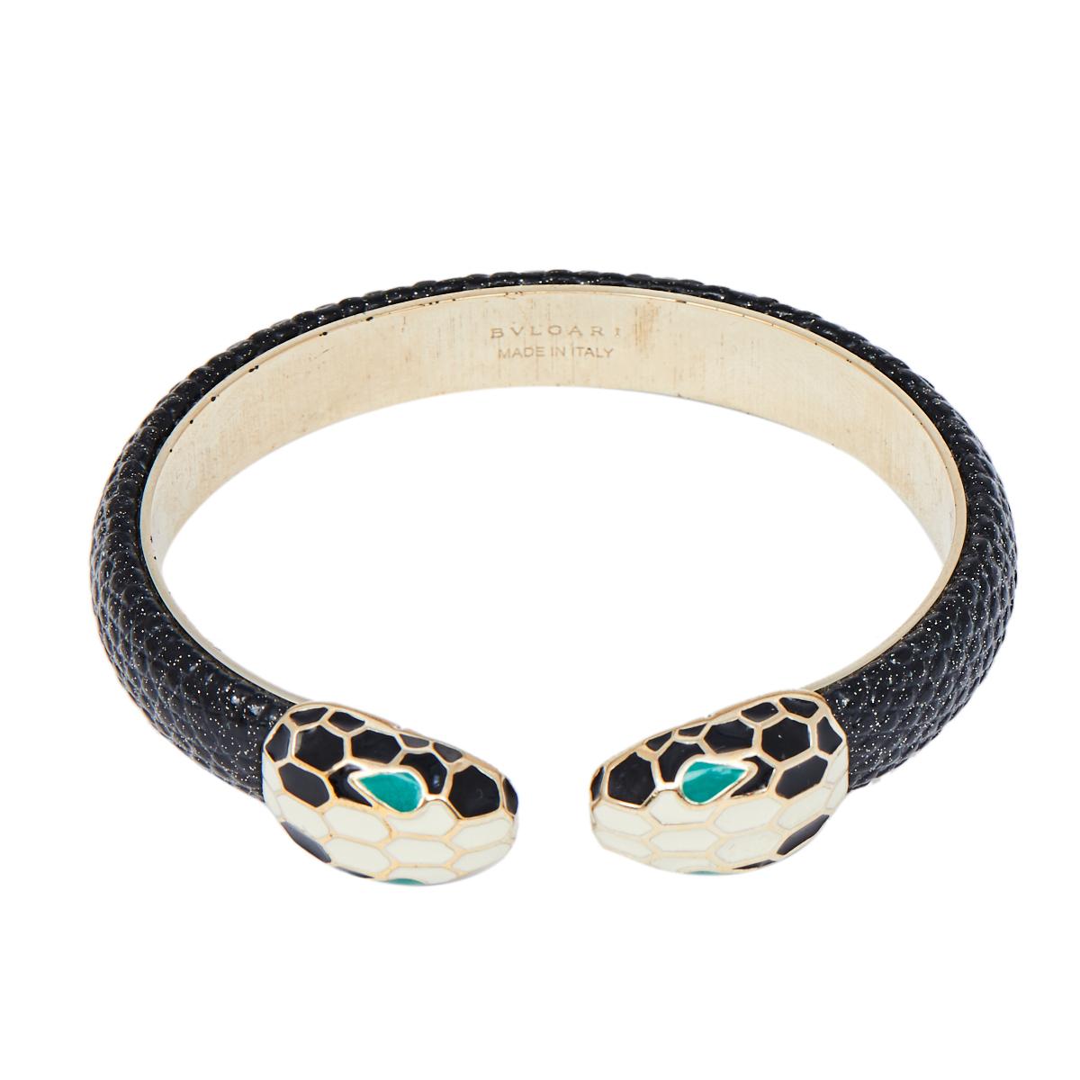 Created using gold-plated metal and leather, this Bvlgari Serpenti Forever open cuff bracelet is highlighted with Serpenti heads on its ends coated with enamel. It's a signature Bvlgari style that you'll love wearing.

Includes: Original Box,