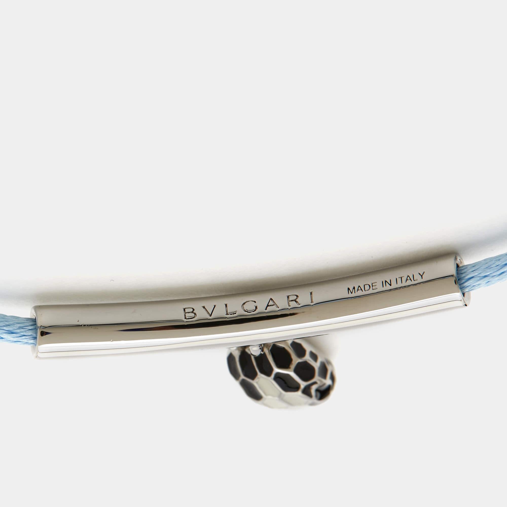 The Bvlgari Serpenti Forever bracelet is an exquisite accessory that intertwines luxury and style. Featuring the iconic serpent head in silver-tone, adorned with enamel detailing, it elegantly coils around the wrist, complemented by a sleek cord,