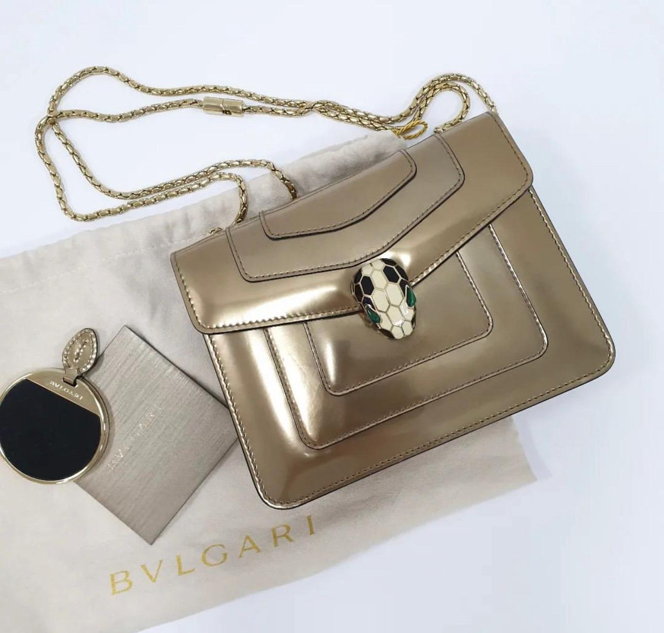 Defined by its snakehead lock hardware - the hallmark of Bvlgari's Serpenti collection - this luxurious Forever cross body bag is an heirloom in the making.
Crafted with distinction from smooth metallicleather, the panelled design boasts a flap