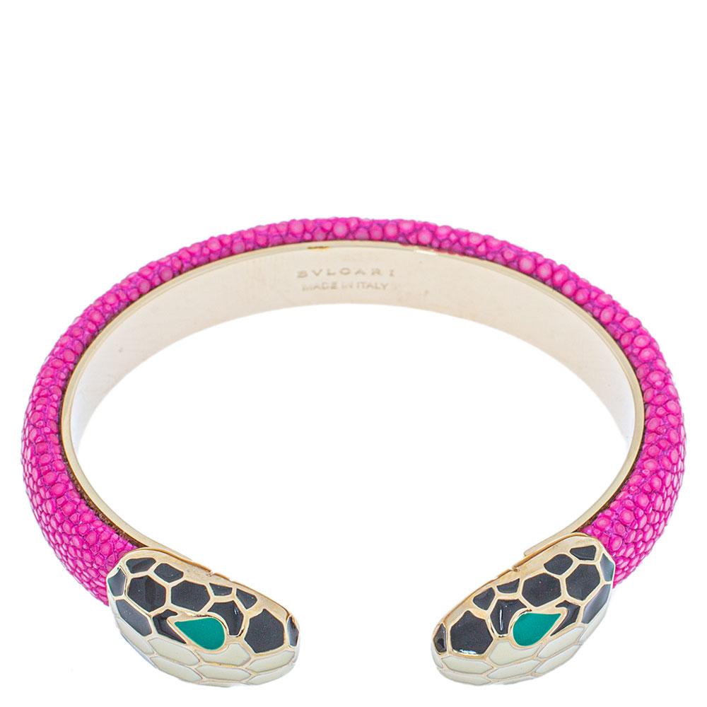 Exuding glamour and classic style, this pink bracelet from Bvlgari is a gold plated metal creation that is enhanced with Galuchat leather and the brand's iconic Serpenti head motifs adorned with enamel. This open cuff style bracelet is so pretty