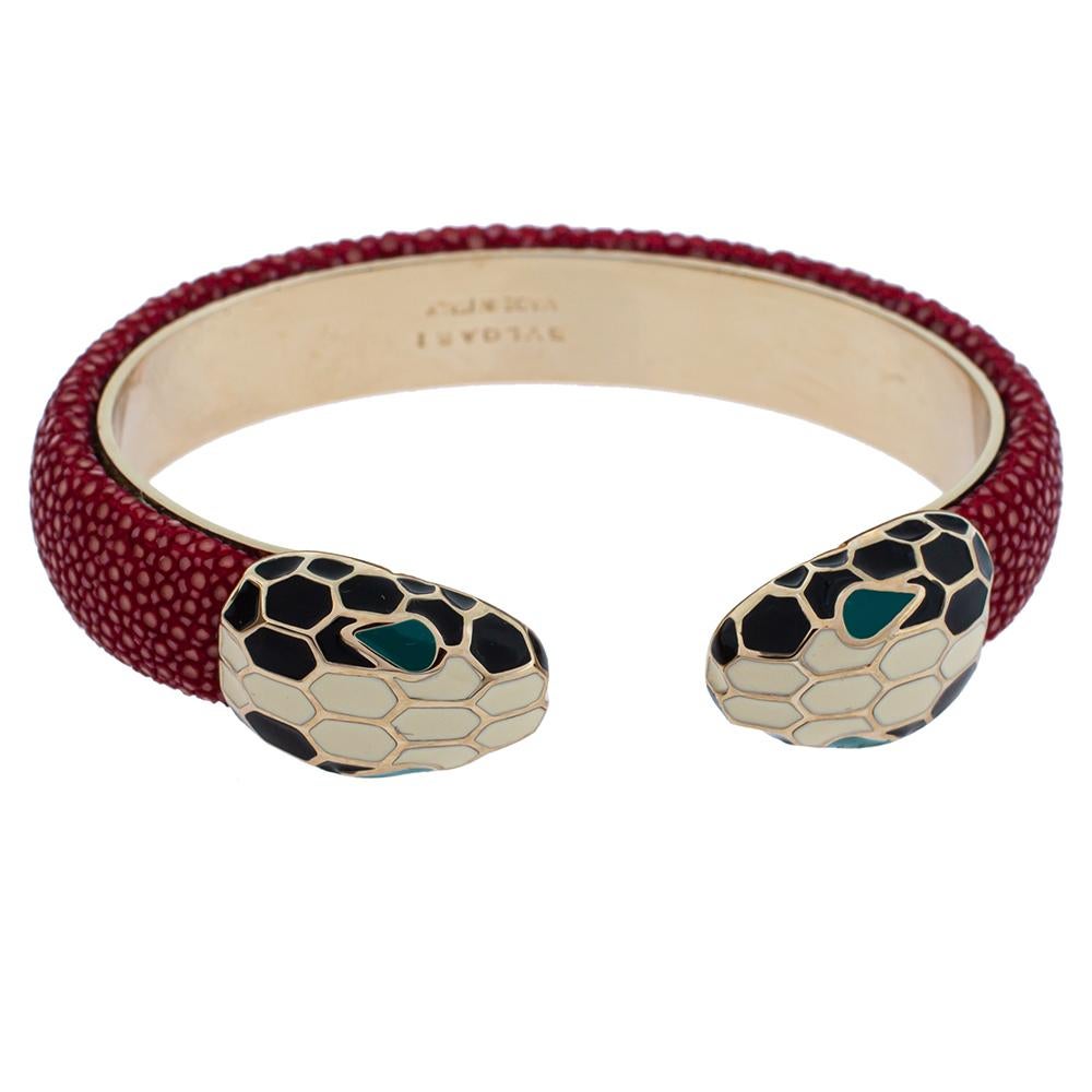 Exuding glamour and classic style, this stunning bracelet from Bvlgari is a gold-plated metal creation that is enhanced with Galuchat leather and the brand's iconic Serpenti head motifs adorned in enamel. This open cuff style bracelet is so pretty