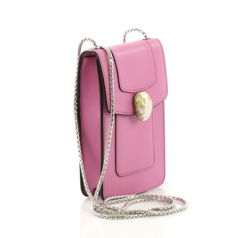 This Bvlgari Serpenti Forever Wallet on Chain Leather Vertical, crafted in pink leather, features a snake-inspired chain strap, serpenti head with malachite eyes, and silver-tone hardware. Its snap button closure opens to a pink leather interior