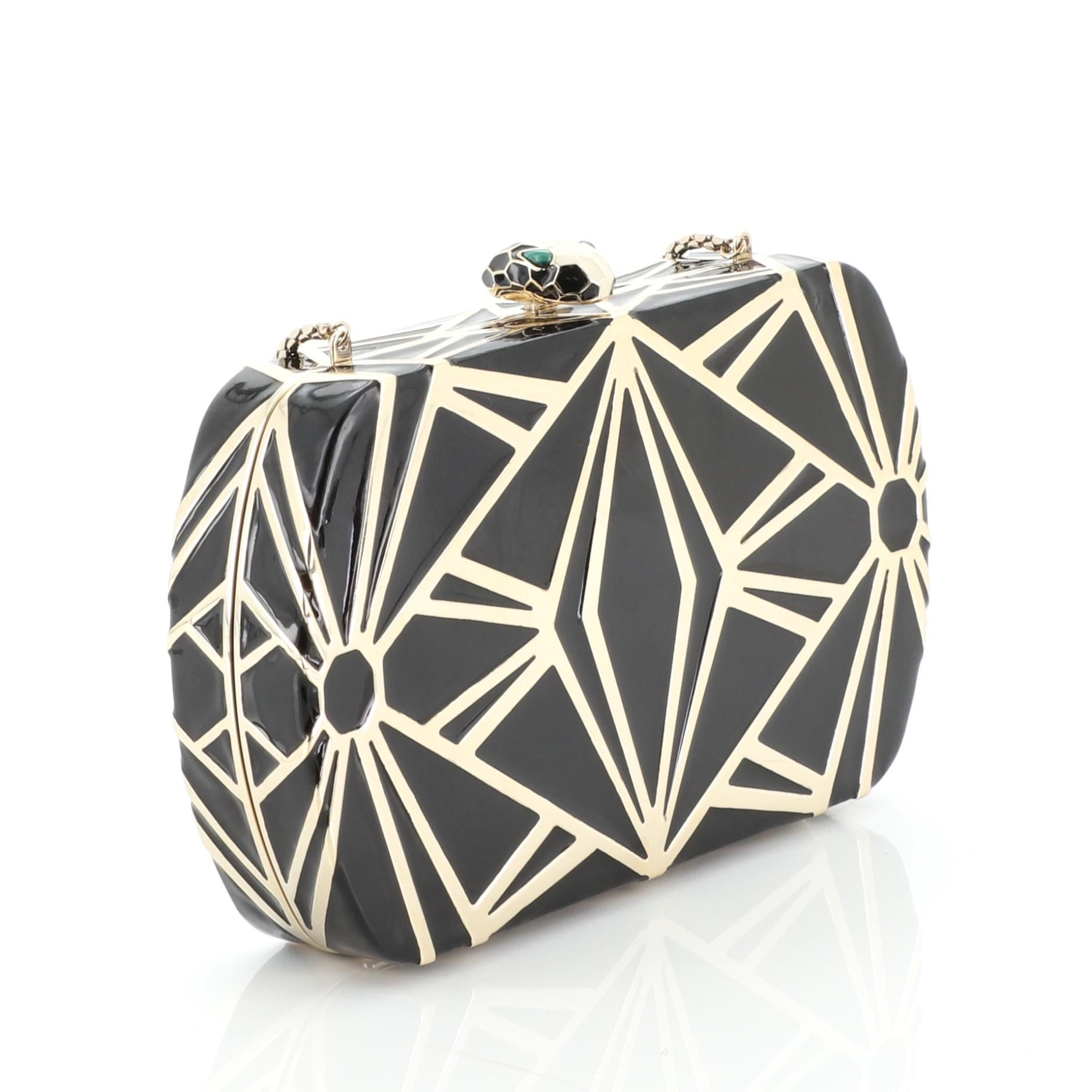 This Bvlgari Serpenti Minaudiere Metal with Enamel, crafted in black metal, features a snake chain strap, embellished Serpenti snakehead and gold-tone hardware. Its push-lock closure opens to a green leather interior divided into three compartments.