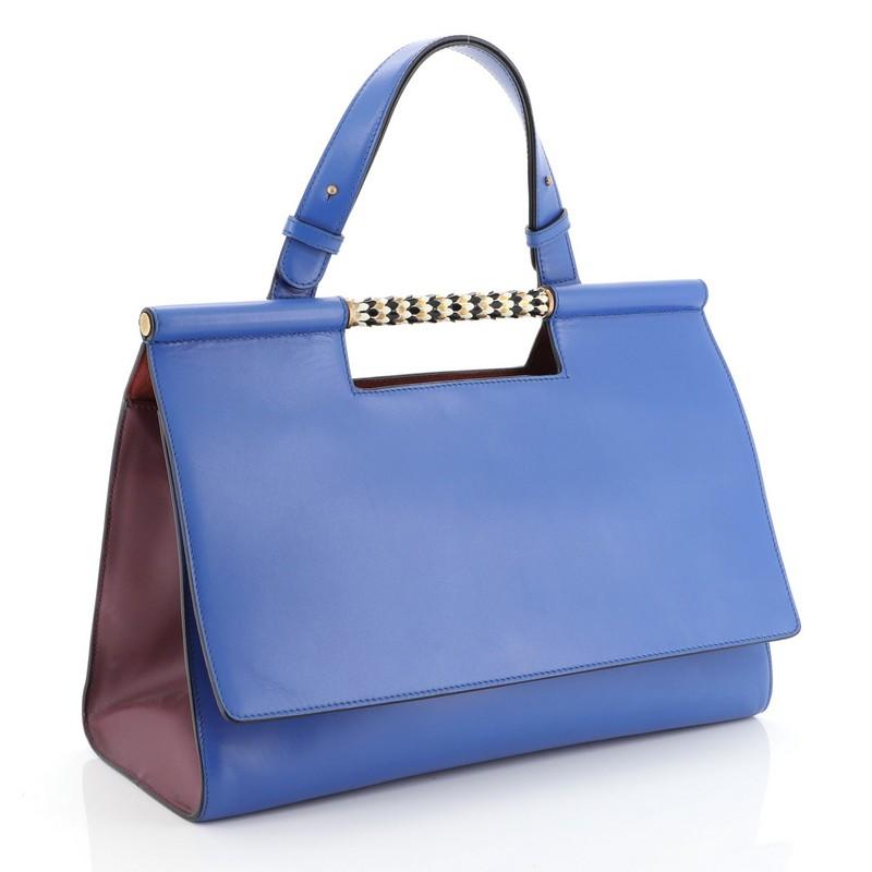 This Bvlgari Serpenti Scaglie Day Bag Leather, crafted in blue leather, features an enamel scaled bar handle, leather top handle, protective base studs and gold-tone hardware. It opens to a red microfiber interior with zip pocket. 

Estimated Retail