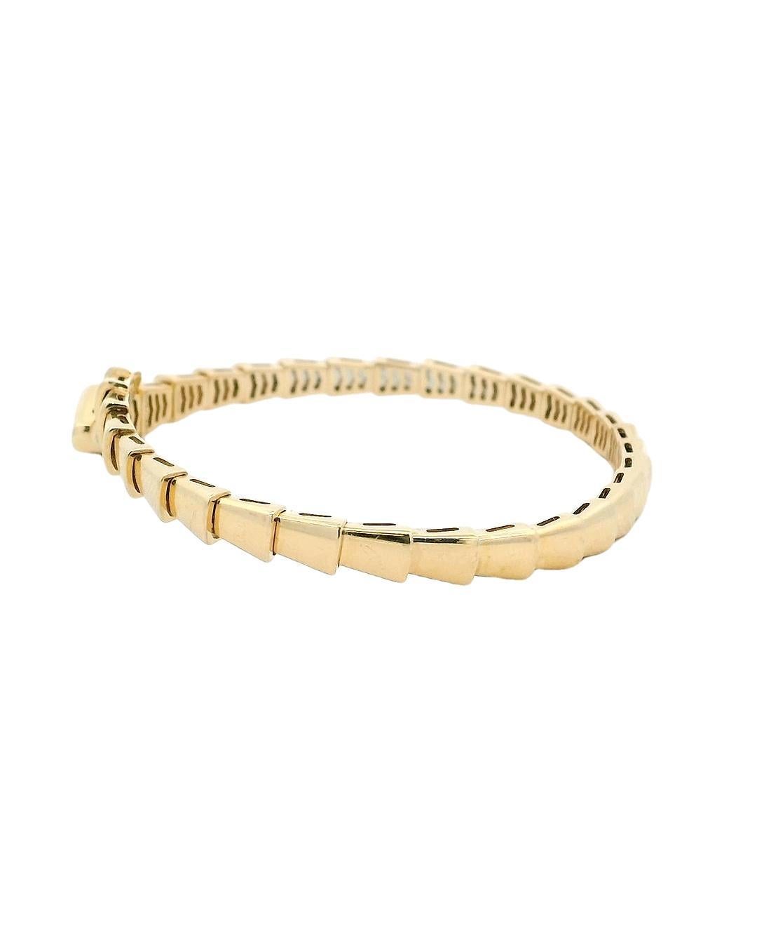 A study in form and elegance.

This striking bracelet by Bvlgari showcases a sleek, modern design crafted in 18k yellow gold. The piece features a series of pointed, geometric segments that create a bold, continuous line. The open-ended design