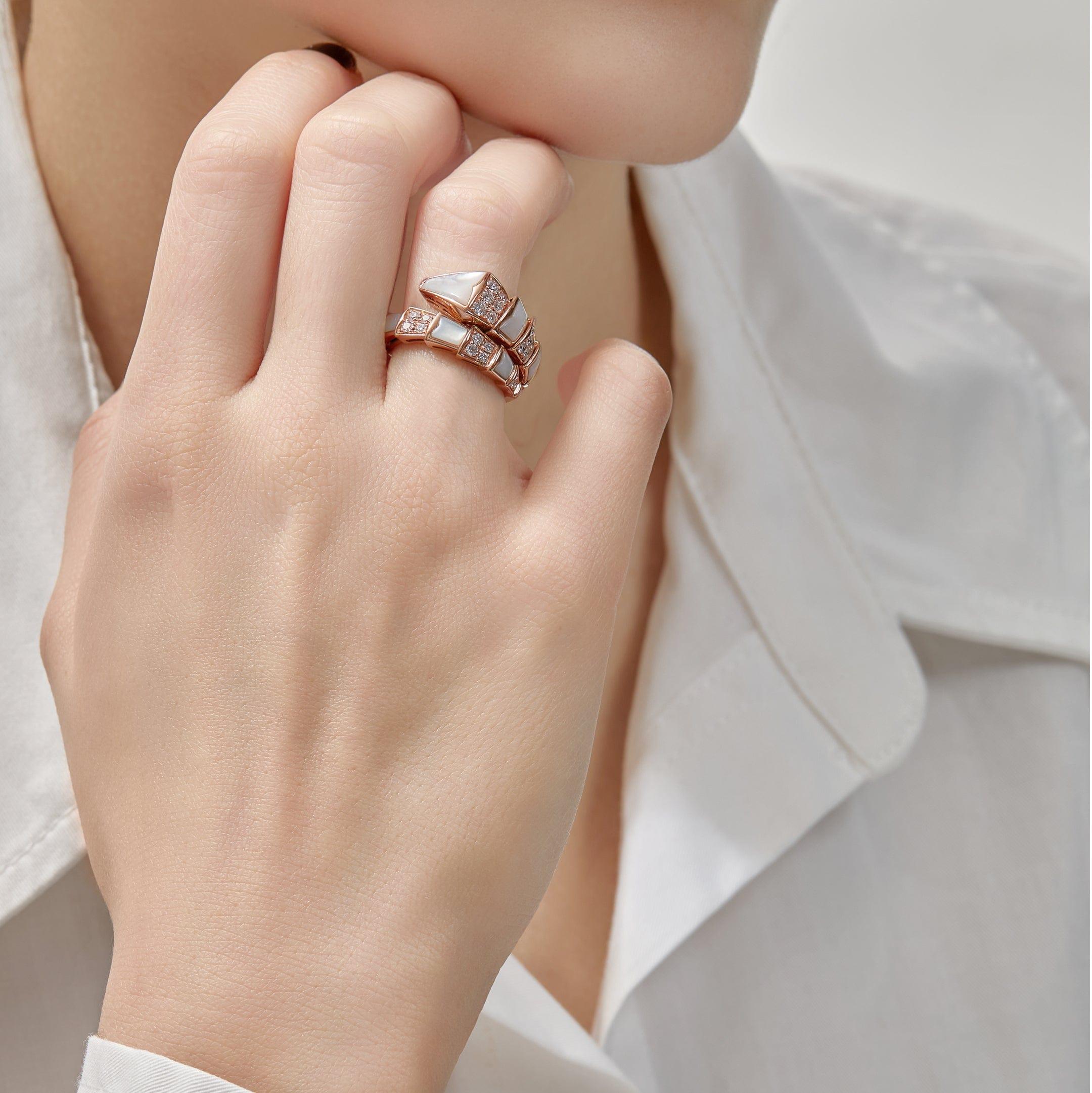 A true statement jewel, this pre-owned Bulgari Serpenti Viper ring in like new condition is a softer rendition of the Italian jewelry house's iconic symbol, thanks to glistening mother-of-pearl. The material is interspersed with diamonds, all set in