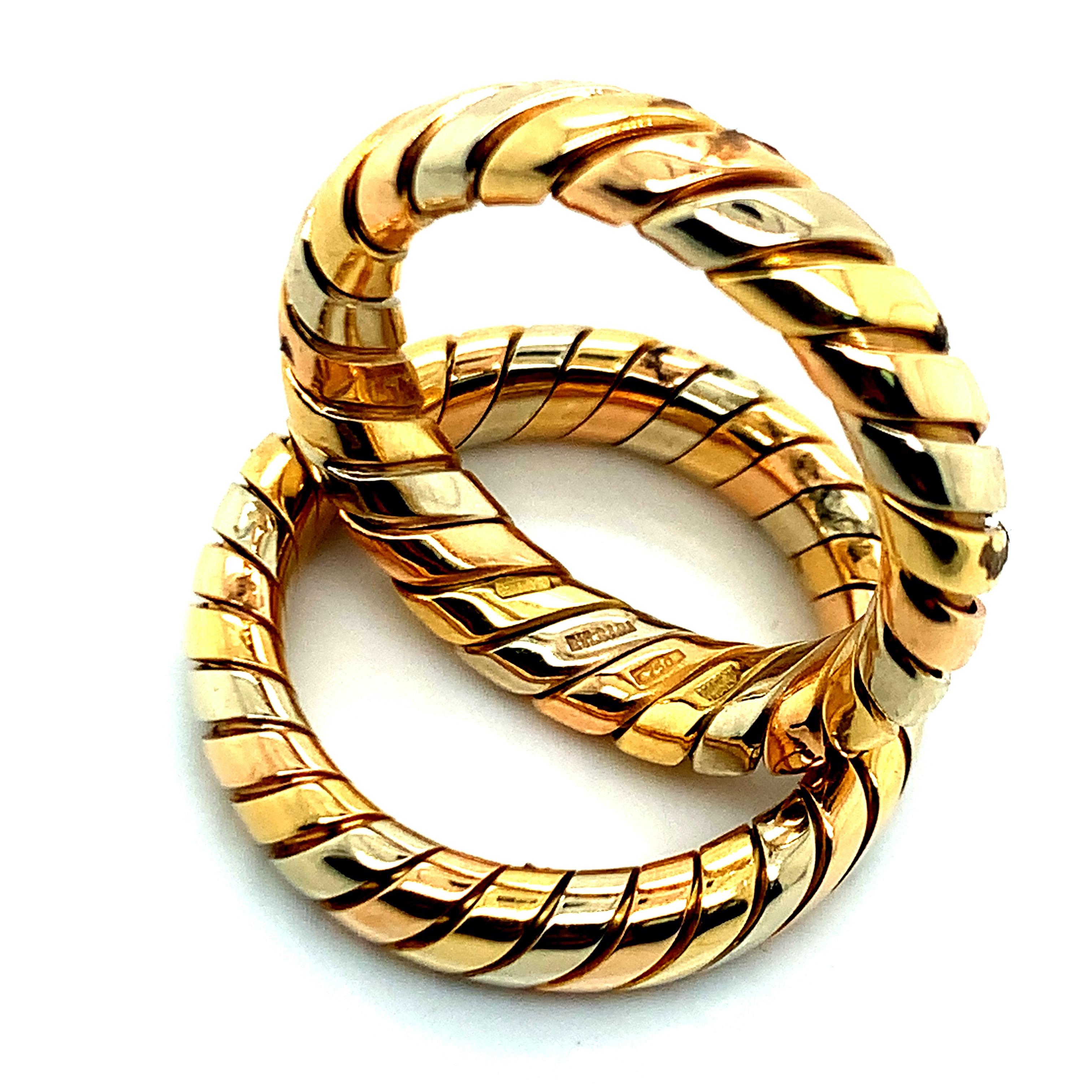 From the Tubogas collection, this set of two Bvlgari rings is made out of three 18 karat gold: yellow, white, and rose. Together, they weigh 13.1 grams. Size 6.5. 