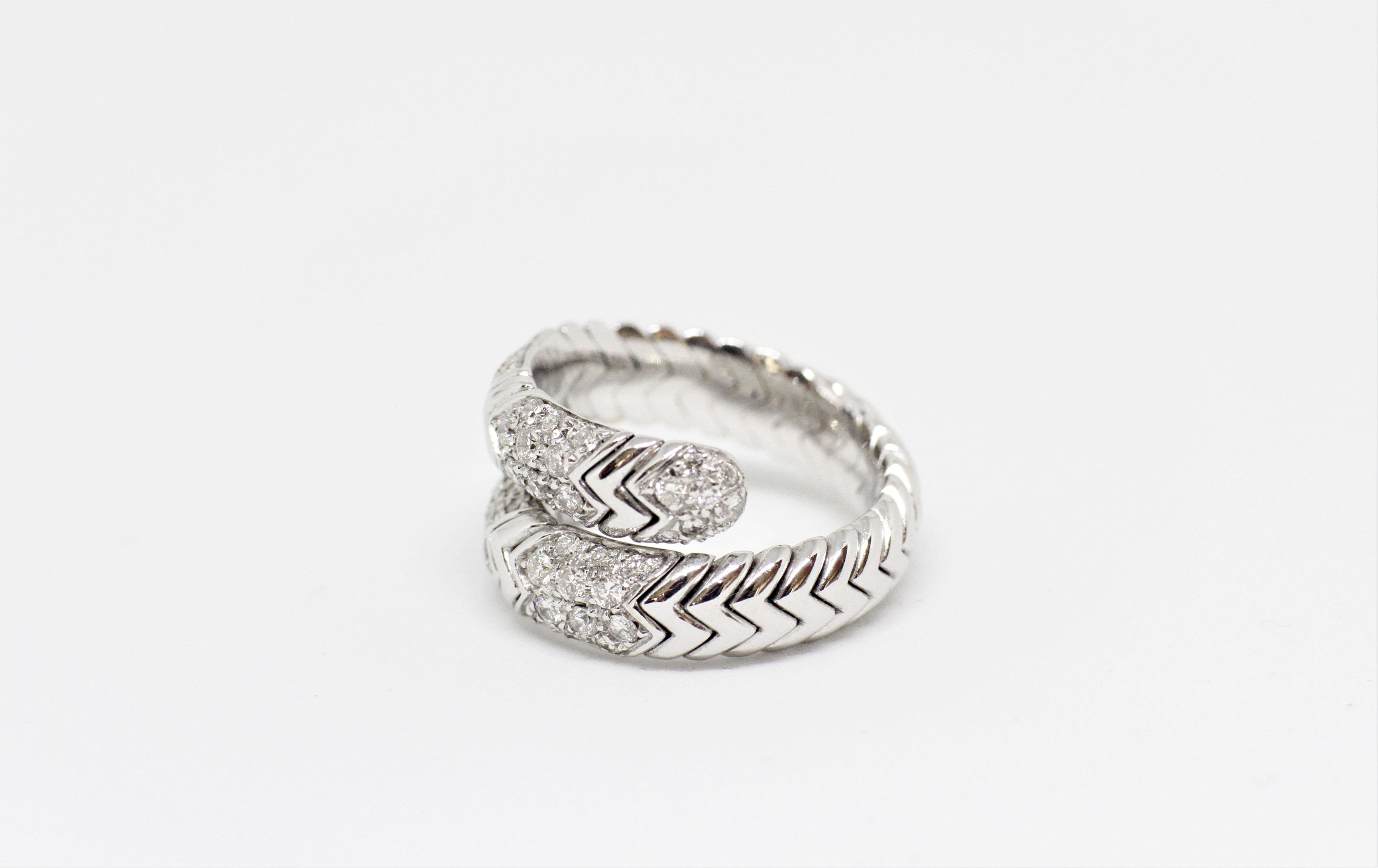Bulgari Spiga ring set with round brilliant cut diamonds in a grain setting with an approximate weight of 0.75 carats. The ring is twisted with a flexible zig zag snake-like design. Marked Italy BVLGARI 18K. UK finger size 'N'.