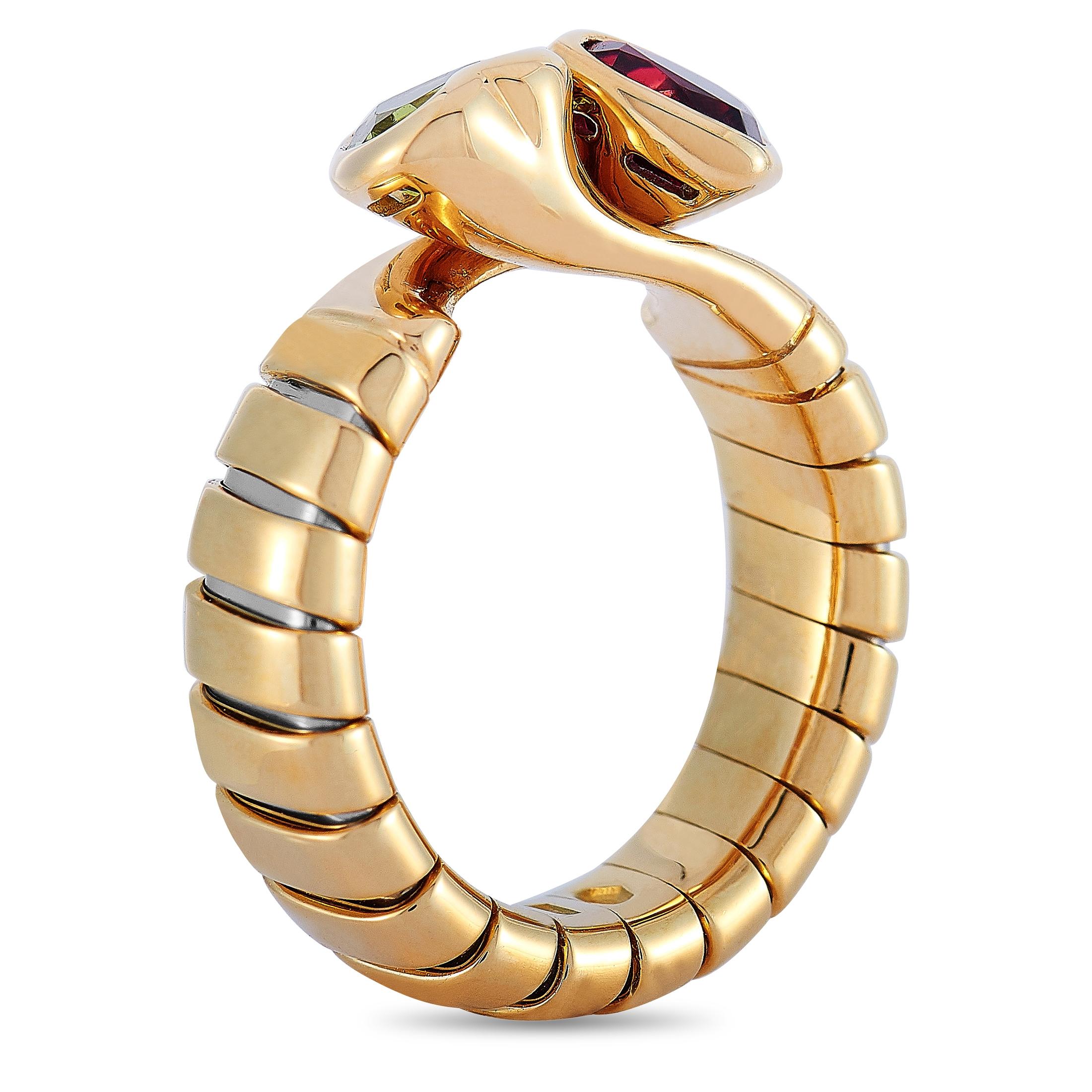 The Bvlgari “Spiga” ring is made of 18K yellow gold and embellished with a peridot and a garnet. The ring weighs 7.5 grams and boasts band thickness of 5 mm and top height of 5 mm, while top dimensions measure 12 by 9 mm.
 
 This jewelry piece is