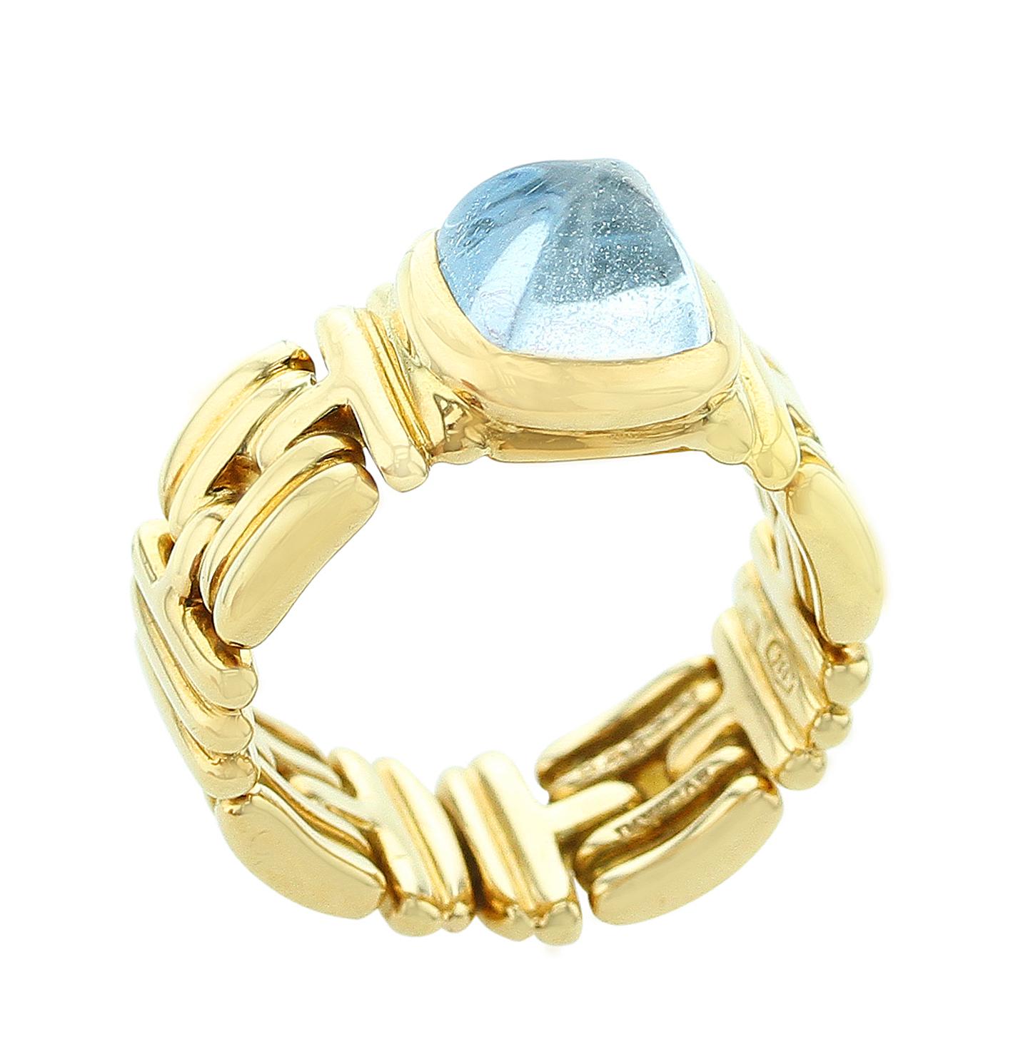 A square blue aquamarine cabochon set in a unique perpendicular pattern mounting style in 18K Yellow Gold. Signed Bvlgari. Ring Size US 6.25.