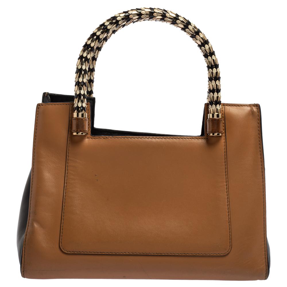 Bvlgari's Serpenti collection has stunning creations like this tote. Crafted from tan-black leather, the Serpenti Scaglie tote is styled with retractable snake handles for an easy carrying experience and a smart silhouette. The bag is complete with