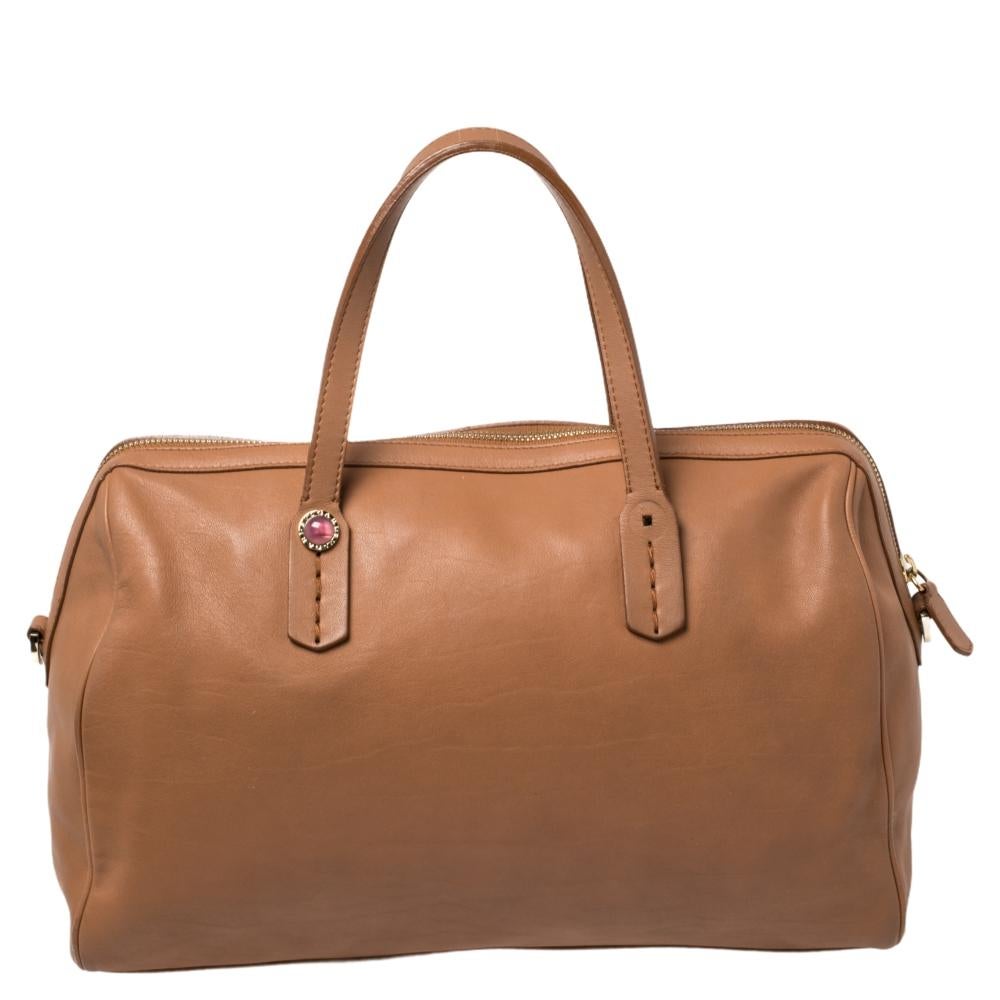 Flaunt your exclusive taste in fashion with this bag from Bvlgari. Carry this brown-hued bag to your next event for a statement-making impression. Tailored with leather, this fun piece is splendid for the daring fashionista.

Includes: Original