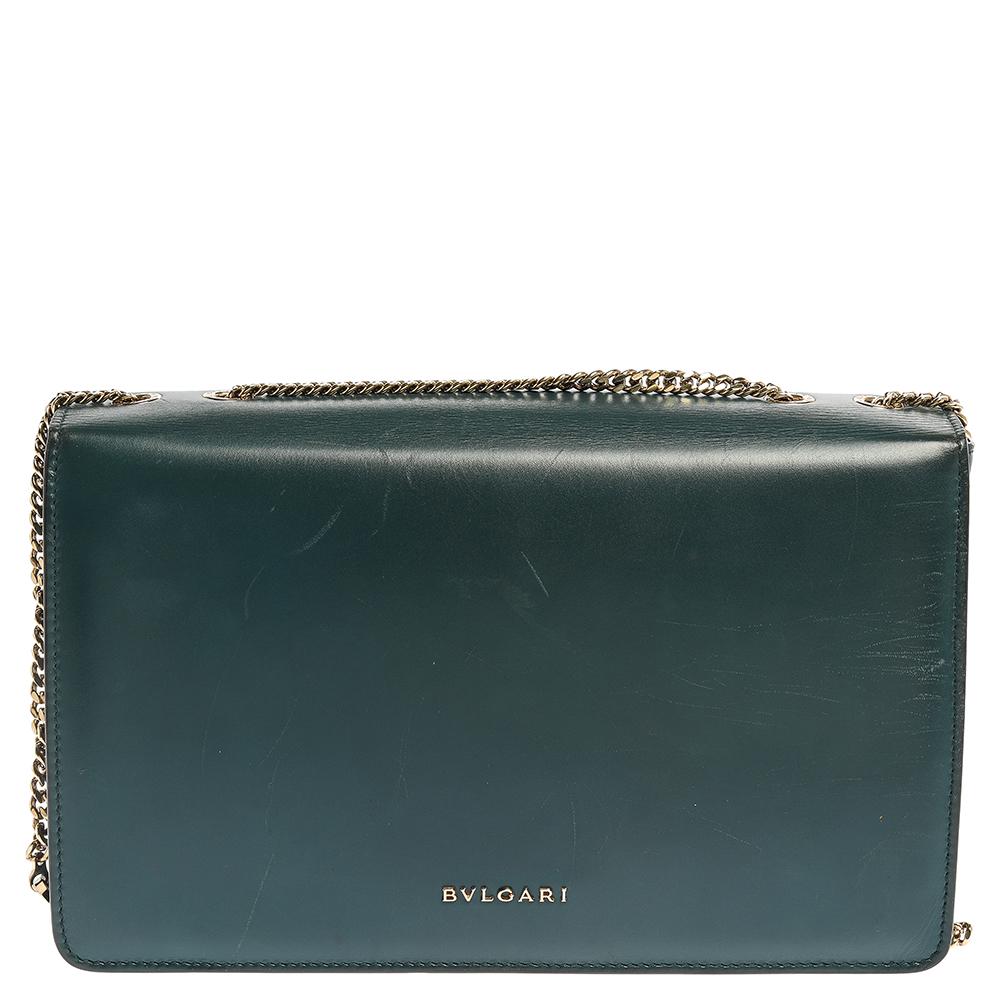 We bring you your best buy of the year in the form of this elegant and charming shoulder bag from the house of Bvlgari. Crafted with precision from leather and perspex it is covered in the shades of teal and black. It has a structured silhouette