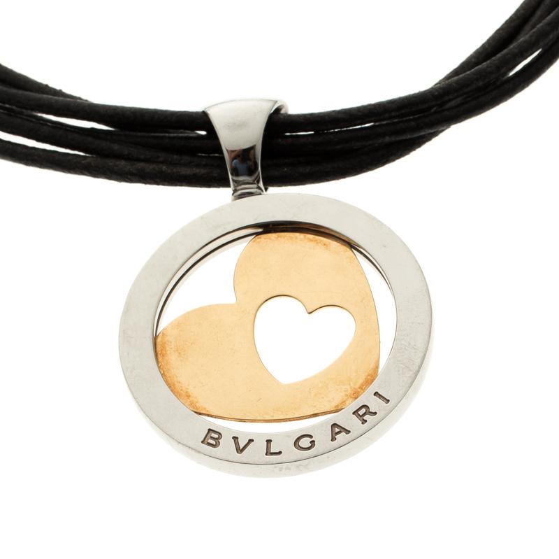 Bvlgari's necklace is effortless, bold and stylish. It features strands of leather cords secured with a lobster clasp closure and centred with a cutesy rounded motif with heart-shaped cut-out pendant crafted in 18k gold and stainless steel. Style