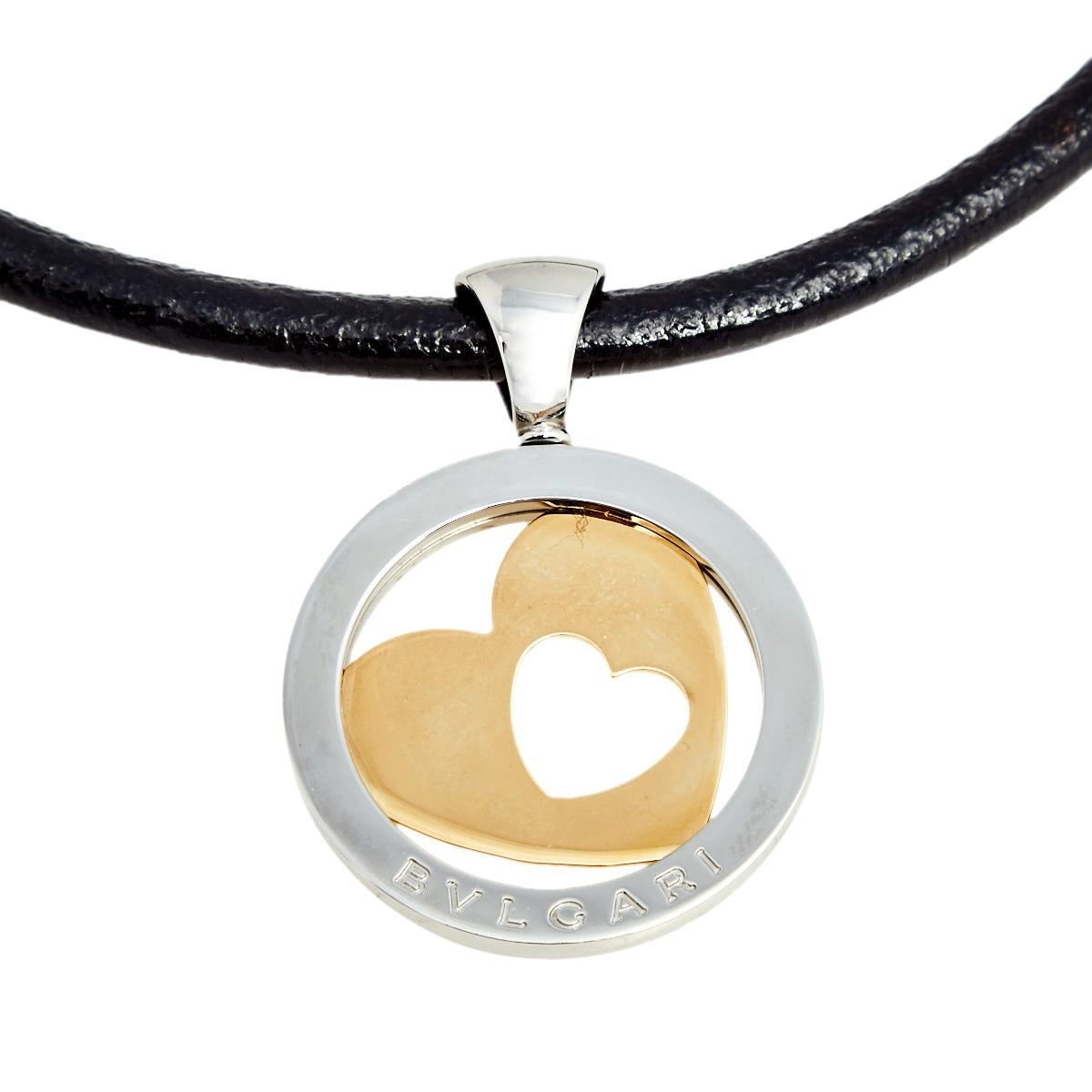 Bvlgari's necklace is effortless, bold, and stylish. It features a strand of leather cord secured with a lobster clasp closure and elevated with a cutesy rounded stainless steel pendant with a heart-shaped cut-out crafted in 18k gold at its center.