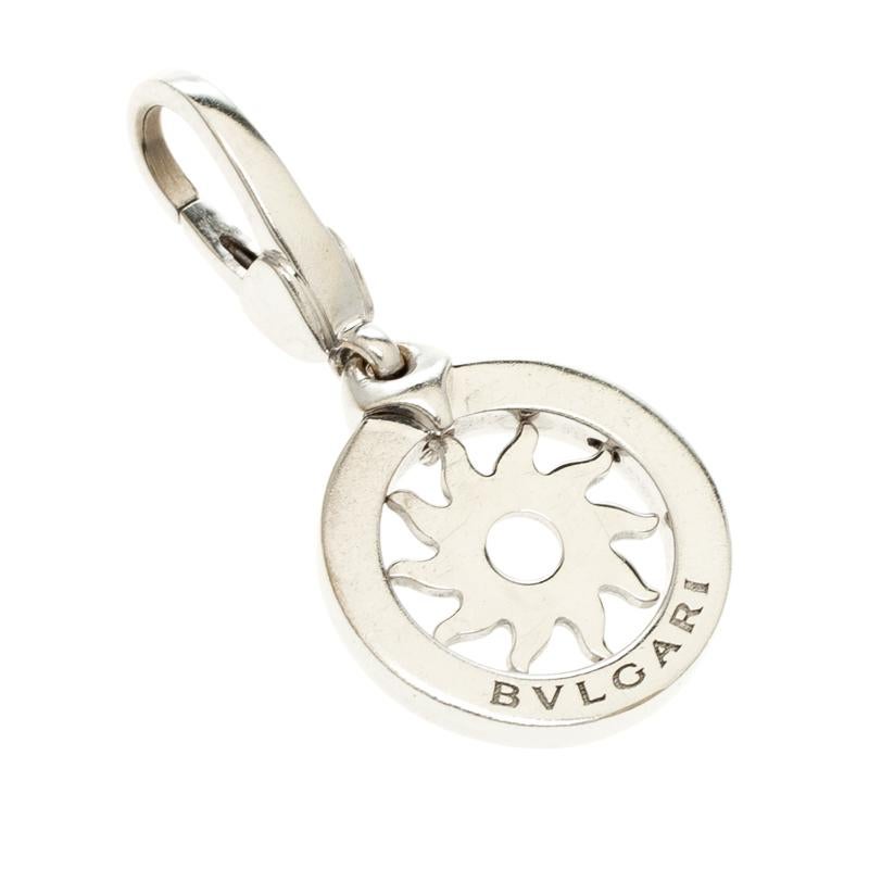 Weighing 3.80 grams, this charm pendant from Bvlgari is versatile as it comes with a lobster clasp which allows you to hook it to necklace chains or handbags. It has been crafted from 18k white gold and designed in a sun sole shape with the label