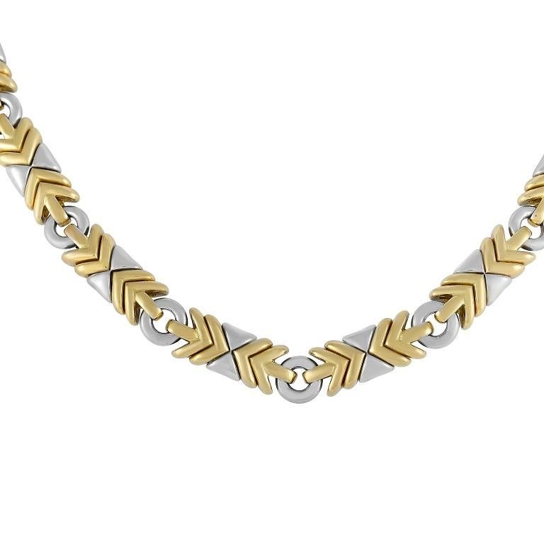 This bold Bvlgari necklace from the Trika collection is sure to attract attention. The necklace chain is crafted from 18K white and yellow gold, forming a variety of unique shaped links. The necklace measures 15.5 inches in length and secures with a