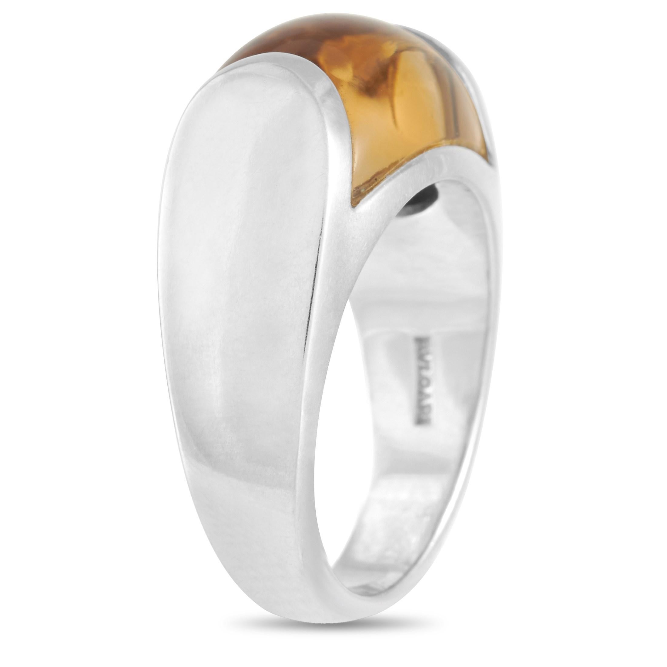 This Bvlgari Tronchetto 18K White Gold Citrine ring retains its simplicity while making a statement. The ring is made with 18K white gold and features a large citrine dome set into the band. The ring is stamped with the Bvlgari brand name on the