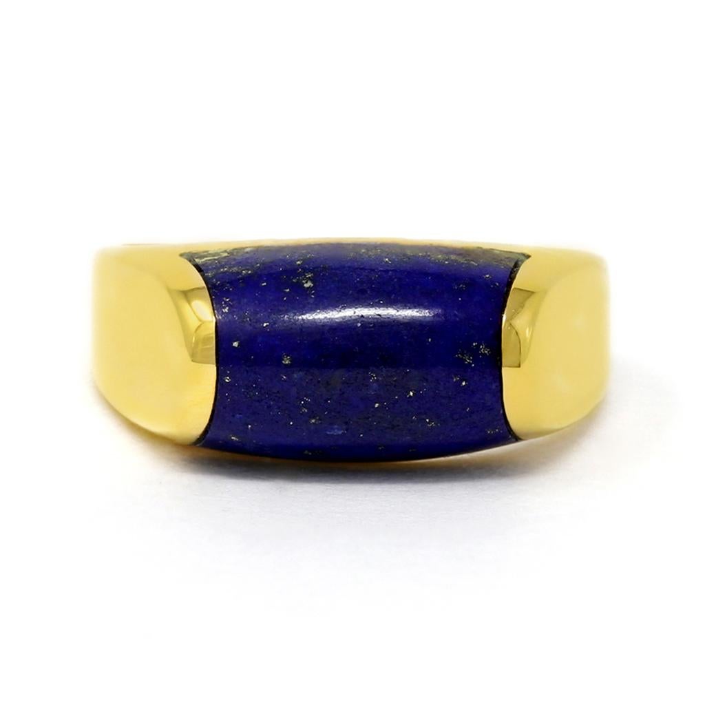 A signed Bulgari ring from the Tronchetto collection set in 18 karat yellow gold featuring a carved lapis lazuli stone perfectly nestled at the top. A high polish 18k yellow gold band with an elegant minimalistic and modern everyday look. The