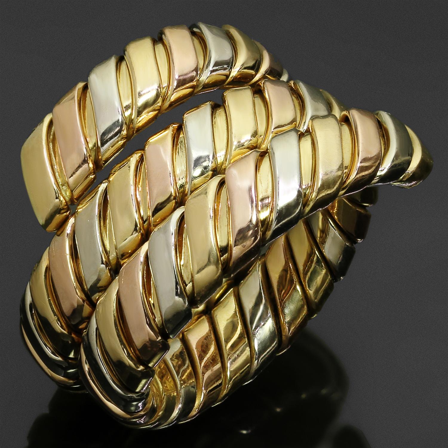 This fabulous Bvlgari ring from the classic Tubogas collection features a slightly adjustable wrap design crafted in 18k yellow, white, and rose gold. Made in Italy circa 1990s. The ring size is adjustable from size 6.5 to 7.5. Measurements: 0.66