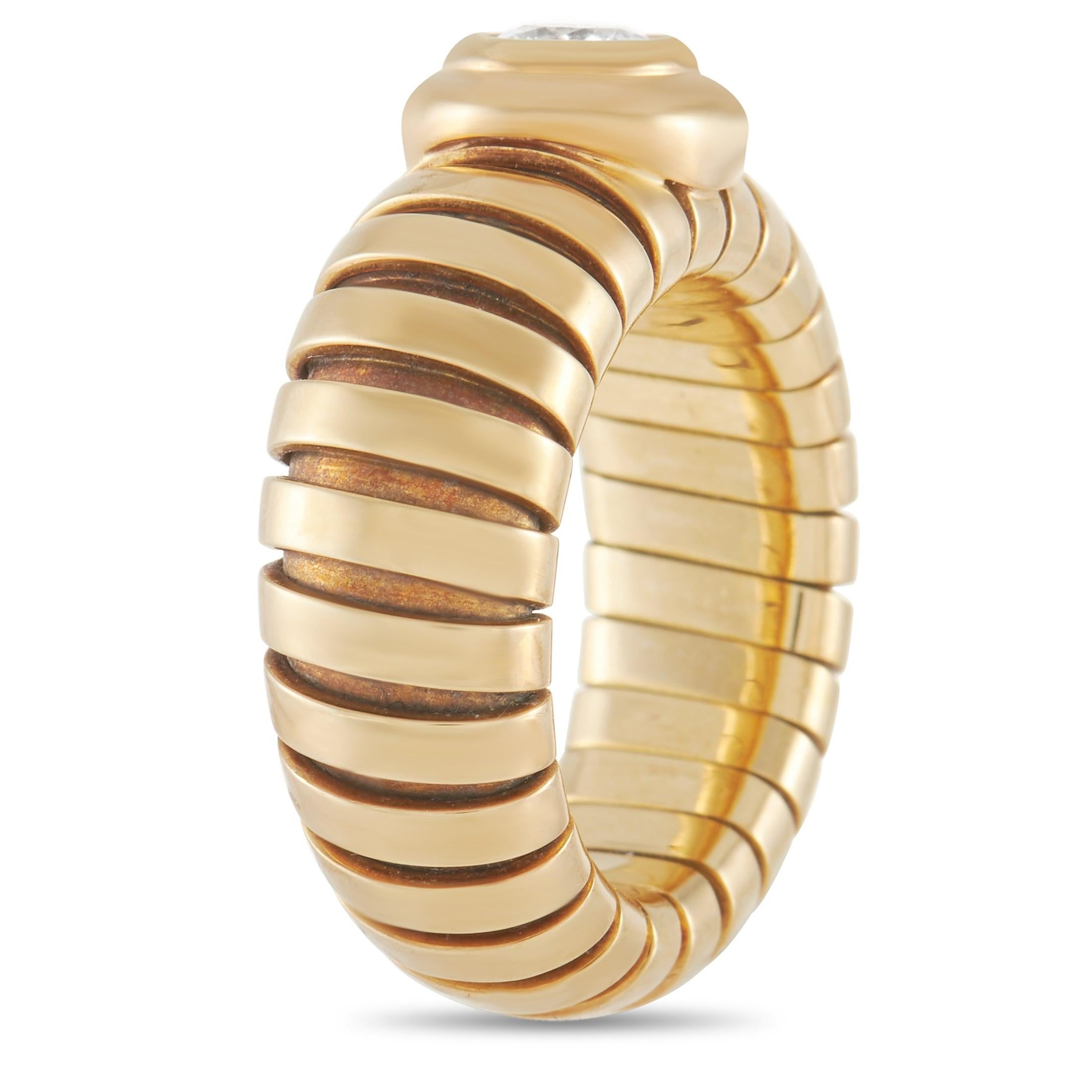 This bold ring from the Bvlgari Tubogas collection is an eye-catching statement piece. The band is made with 18K yellow gold and features almost cut like striations around the outside of the ring. The face of the ring is set with a 0.50 carat round