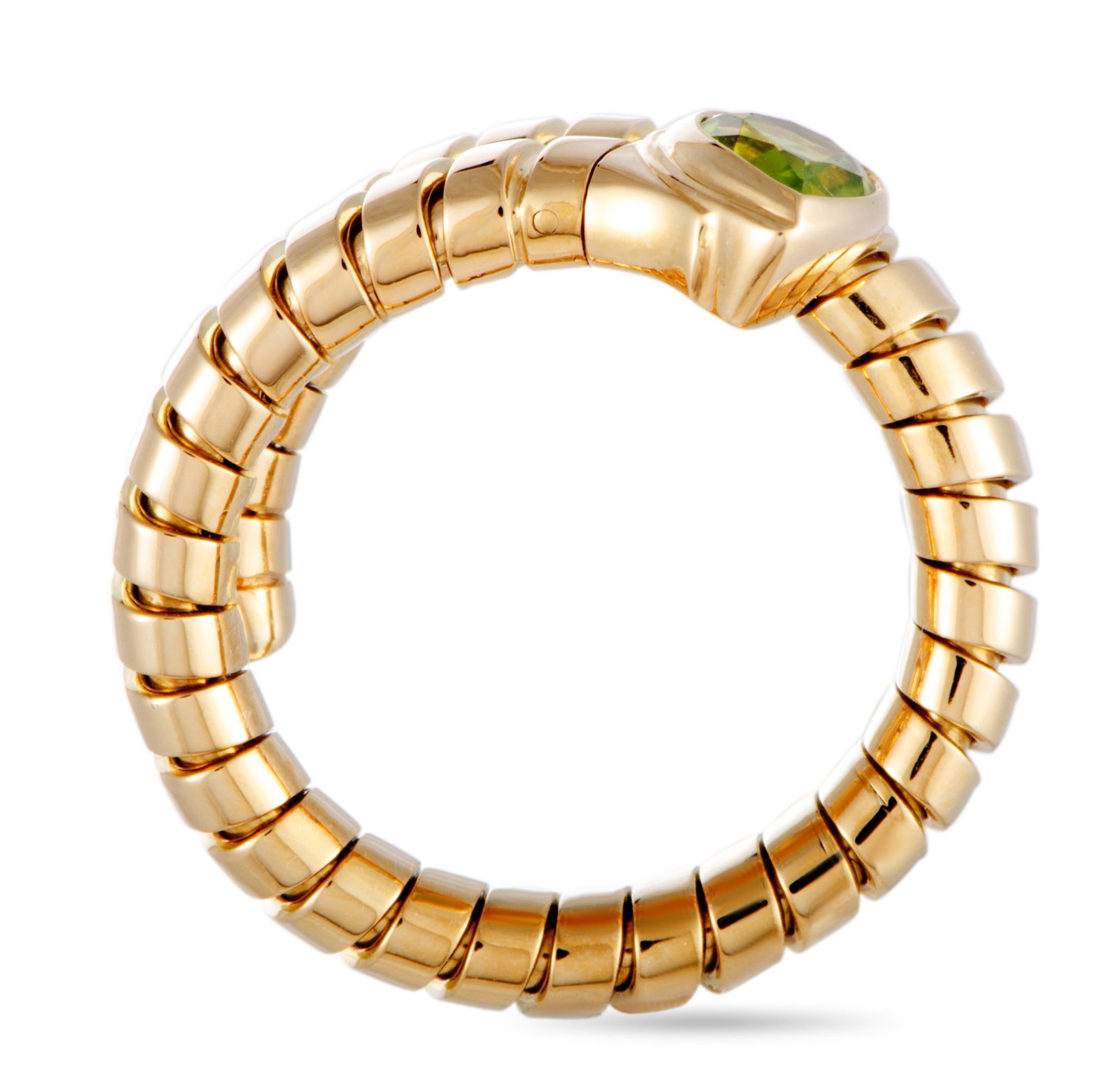 This Bvlgari ring is made of 18K yellow gold and set with a peridot. The ring weighs 9.4 grams, boasting band thickness of 9 mm and top height of 5 mm, while top dimensions measure 12 by 15 mm.

Offered in estate condition, this jewelry piece