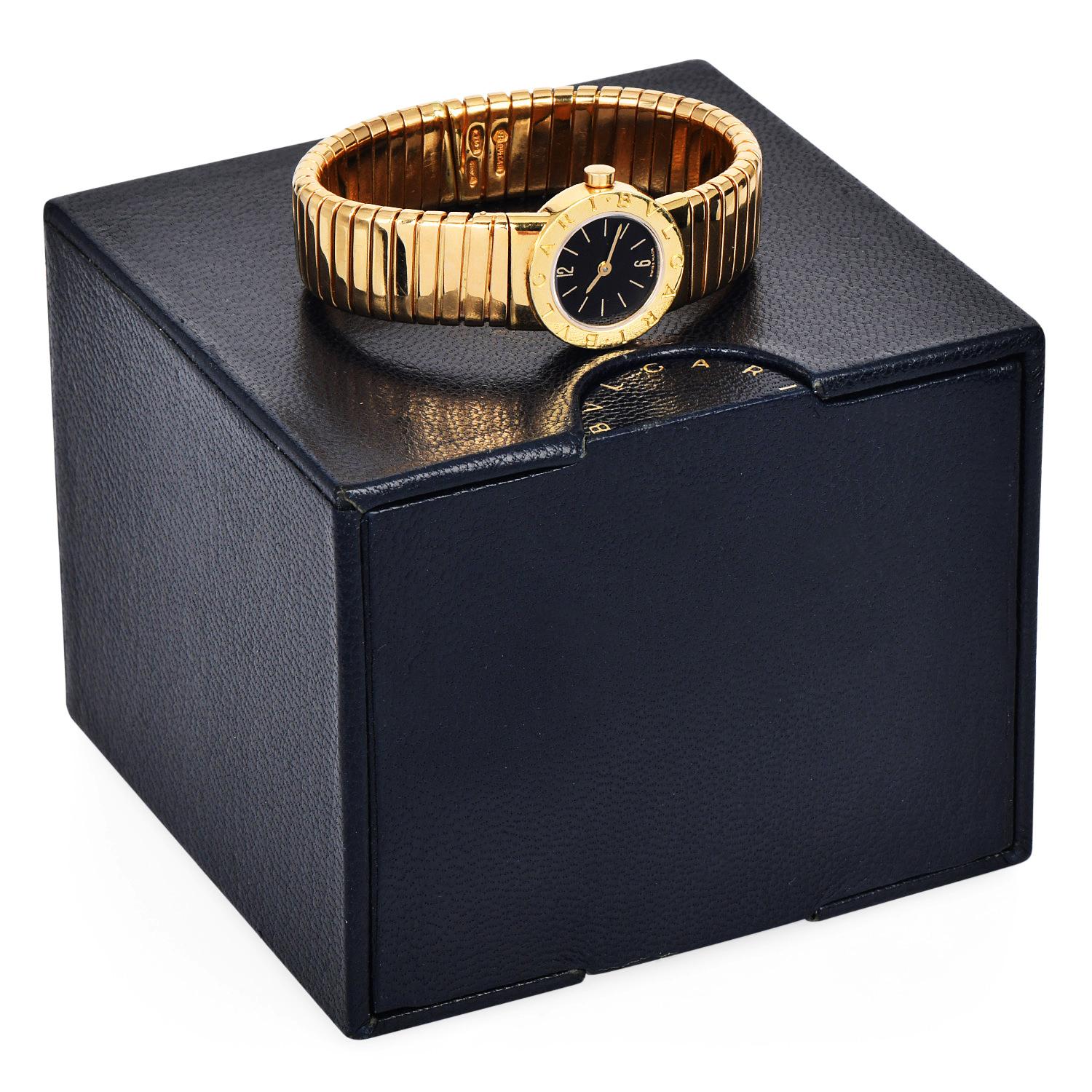 Elevate your style with this Estate 1980s Bvlgari Tubogas Ladies Quartz Watch, reference BB 19 2T.

Crafted with luxurious 18K yellow gold, this elegant timepiece features a sleek 19mm case and an iconic black dial.

The open bangle-style bracelet