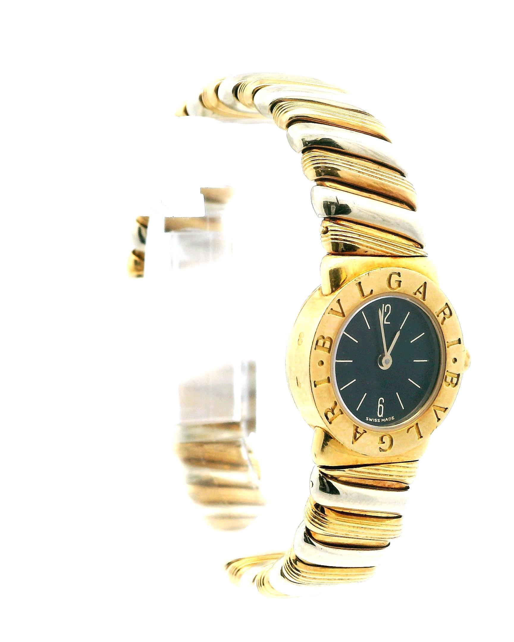 Bvlgari Tubogas BB19 2T Ladies Watch features a 19mm 18K yellow gold case and a fixed 18K yellow gold bezel engraved with the Bvlgari logo. It has a black dial adorned with gold hands, index hour markers, and Arabic numerals at the 6 and 12 o'clock
