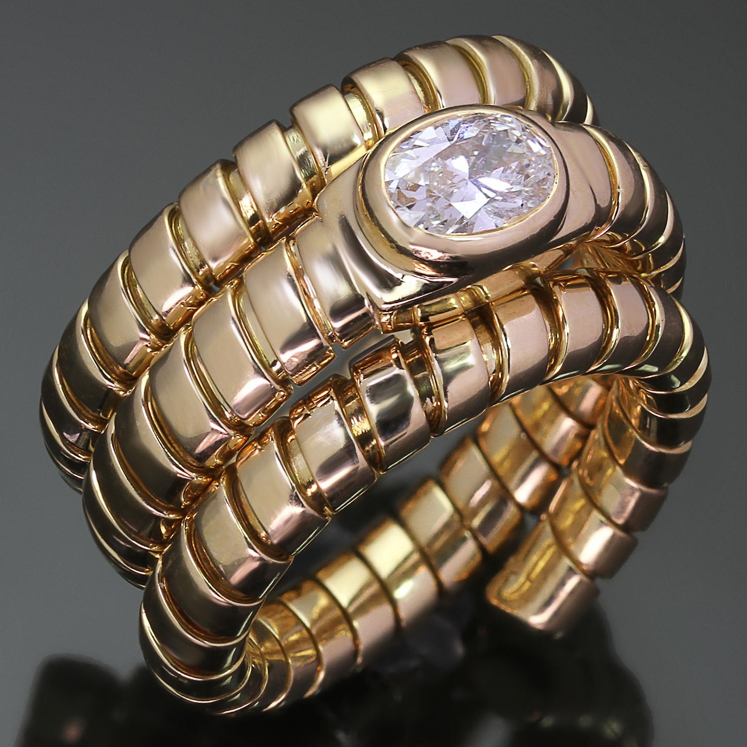This gorgeous authentic Bvlgari ring from the iconic Tubogas collection features a slightly adjustable 3-row wrap design crafted in 18k yellow gold and set with an oval F-G-H VVS2-VS1 diamond. Made in Italy circa 1990s. Measurements: 0.51