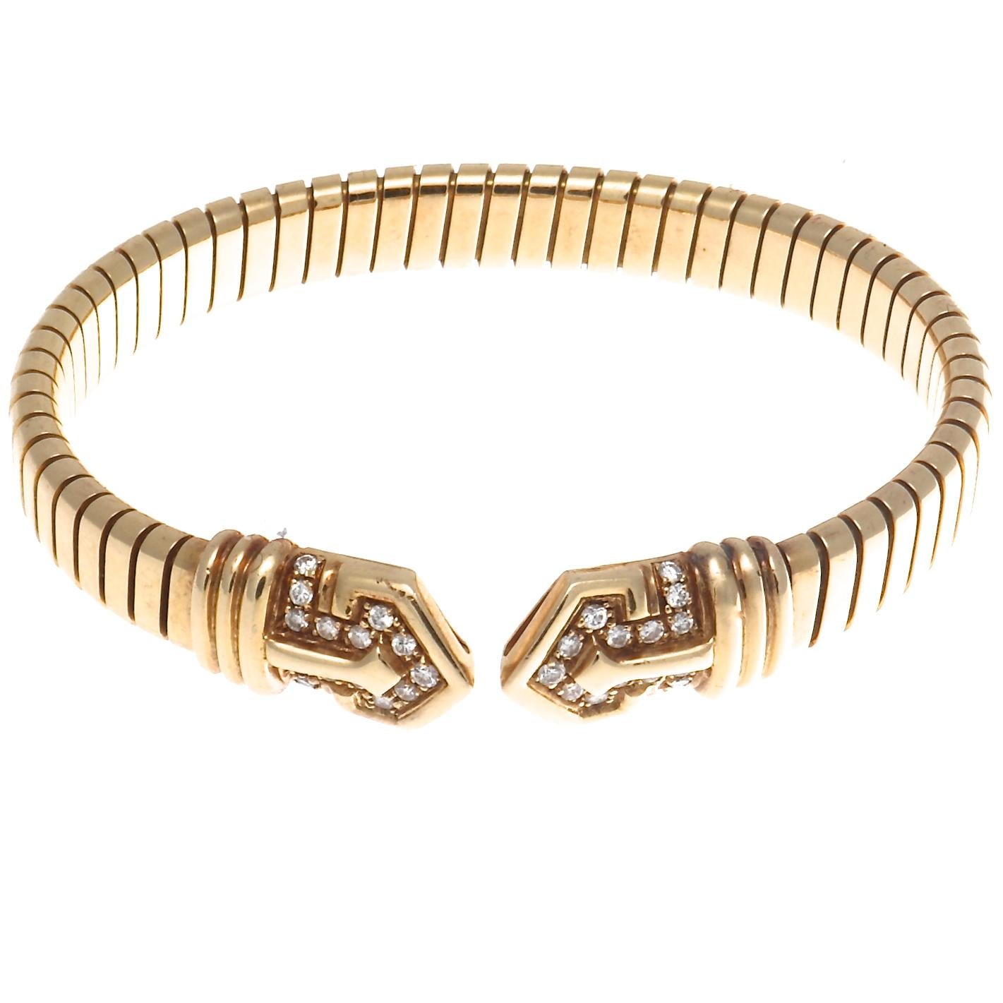 There are 30 round brilliant diamonds in this fabulous Bulgari Tubogas 18k gold bracelet, that weigh approximately 0.45 carats and are graded as E,F color VS clarity. Signed Bvlgari and stamped with makers mark. Circa 1960's. Measures 2 1/4 inches X