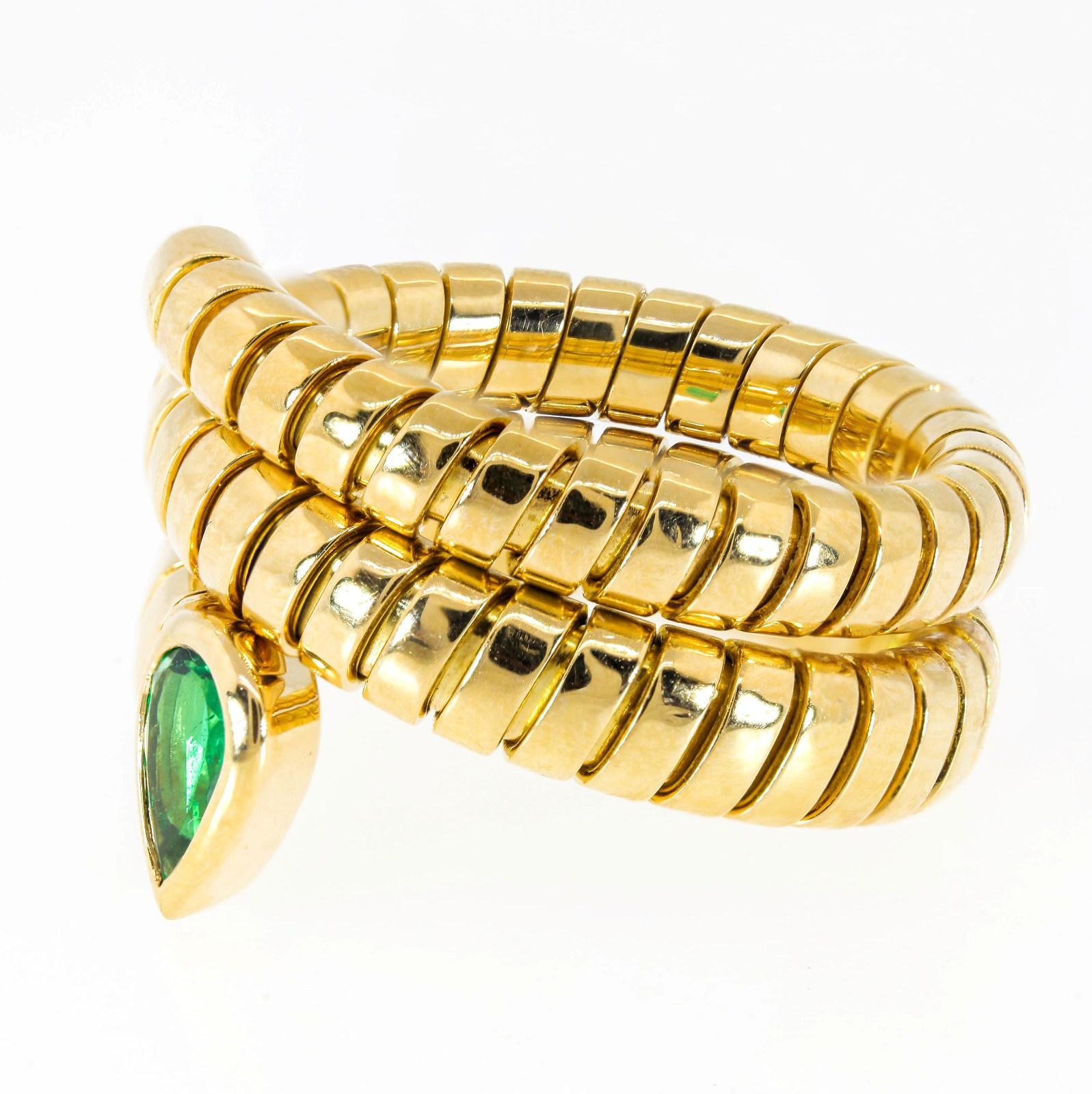 This creation of Bvlgari's classic Tubogas snake ring features a bezel set pear shape Colombian Emerald.  The triple wrap design tapers from the Emerald to the tail.  A cool joy to wear!