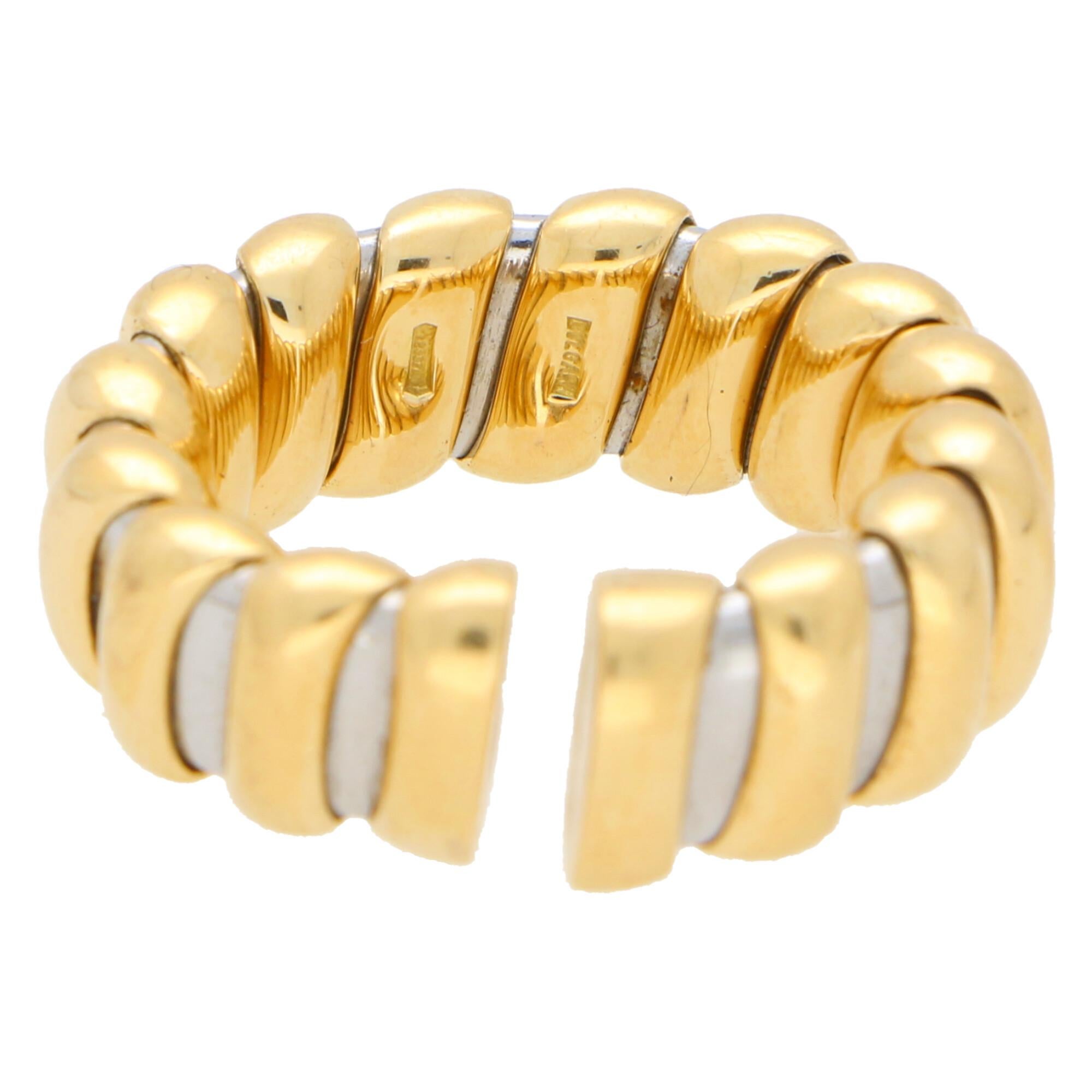 A lovely Bvlgari Tubogas flexible ring  set in 18k yellow gold and stainless steel.

The ring is composed of 16 polished yellow gold pipe bands on top of a flexible stainless steel torque like flexible band. The contrast of the yellow gold against