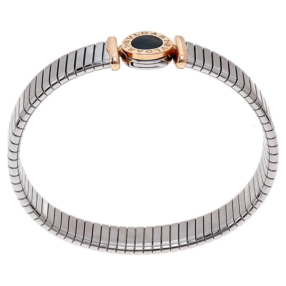 Beautify your wrist with this stunner of a bracelet from Bvlgari. The Bvlgari Tubogas bracelet piece has been crafted from stainless steel in a cuff style and centered with an 18k rose gold detail featuring onyx inlay and brand engravings.

