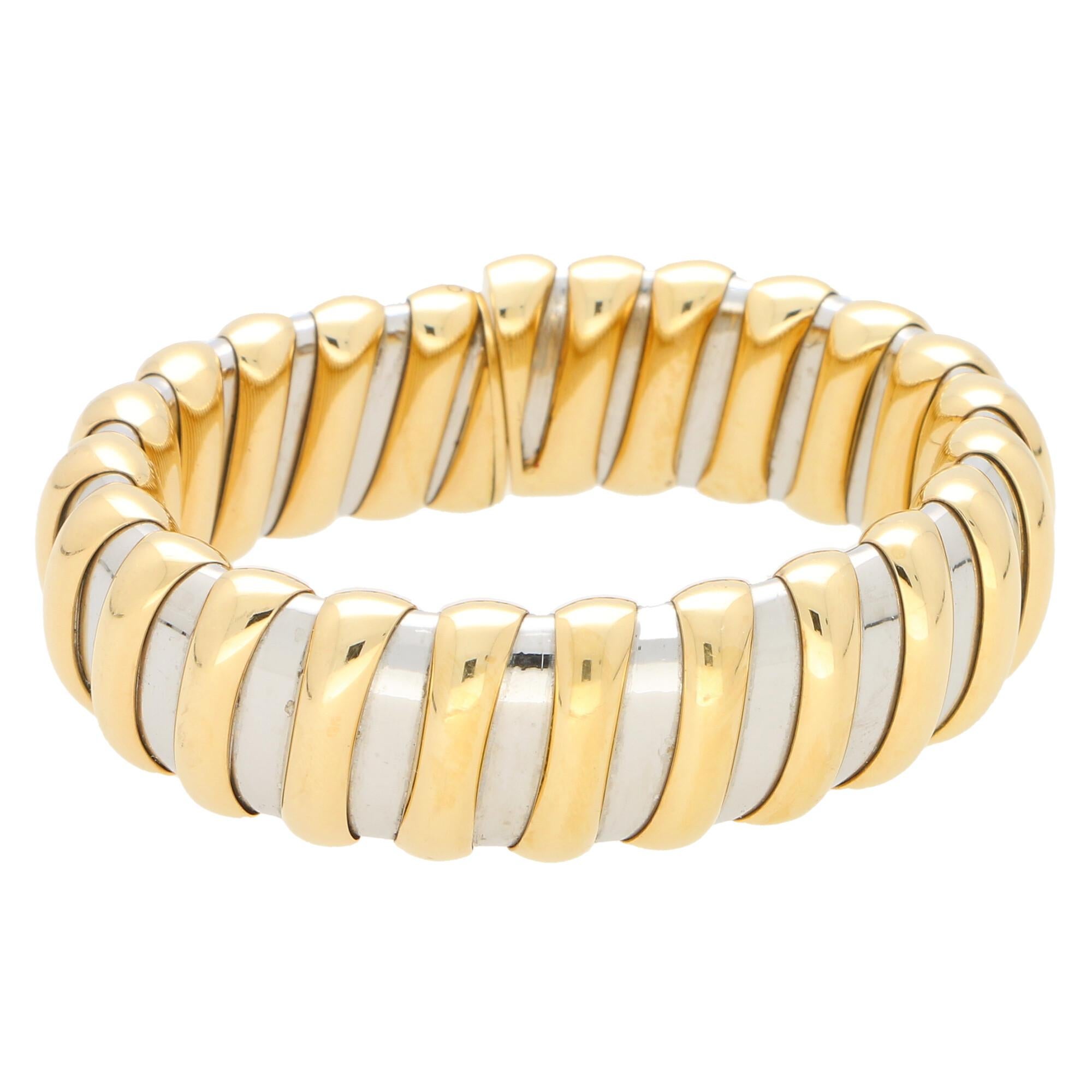 A rather interesting Bvlgari Tubogas torque bracelet set in 18k yellow gold and stainless steel.

The bracelet is composed of 24 polished yellow gold pipe bands on top of a flexible stainless steel torque. The contrast of the yellow gold against the