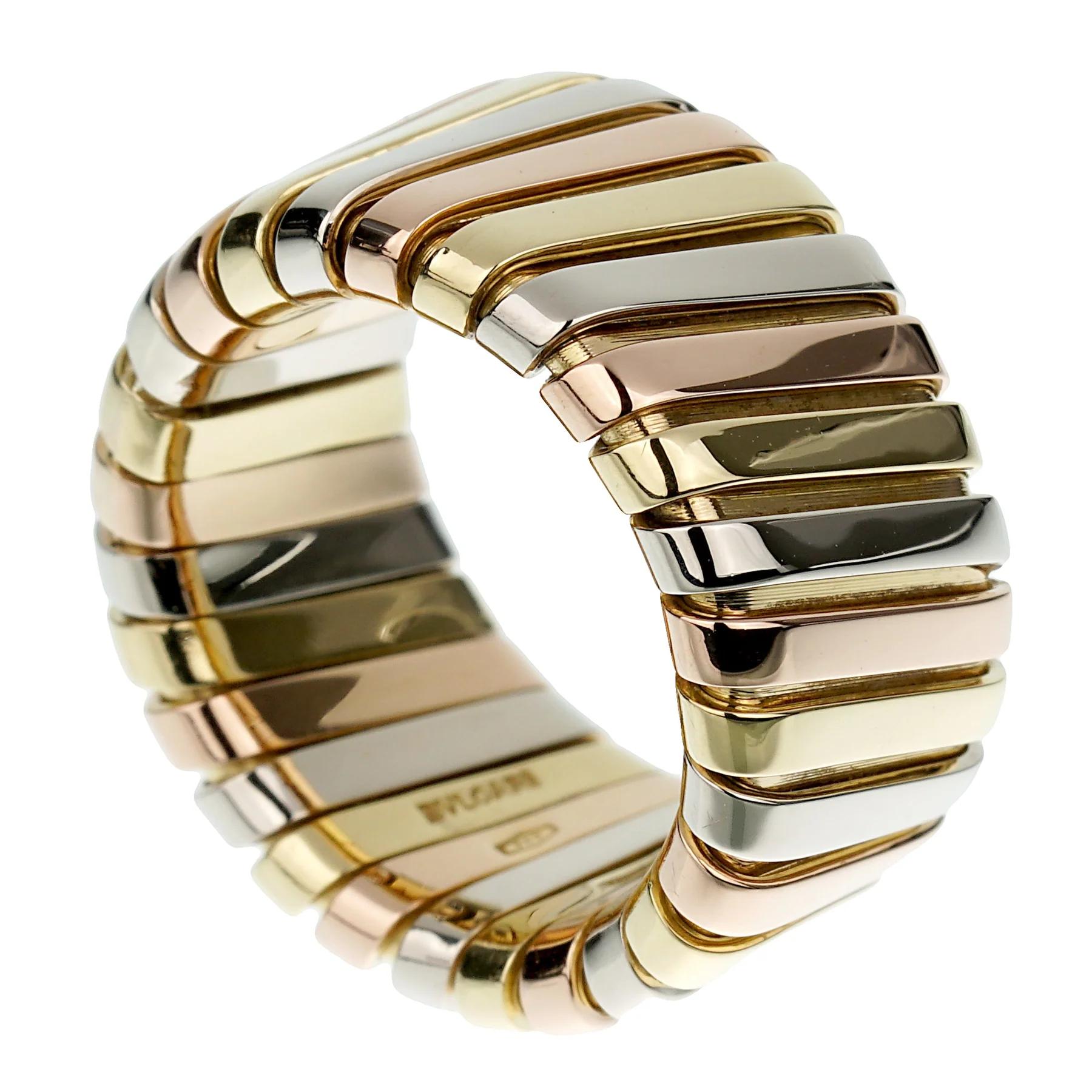 he Bvlgari Tubogas Wide Band Ring is a striking and luxurious piece that showcases the brand's iconic design and expert craftsmanship. This exquisite ring is crafted from a harmonious blend of white, yellow, and rose gold, creating a stunning
