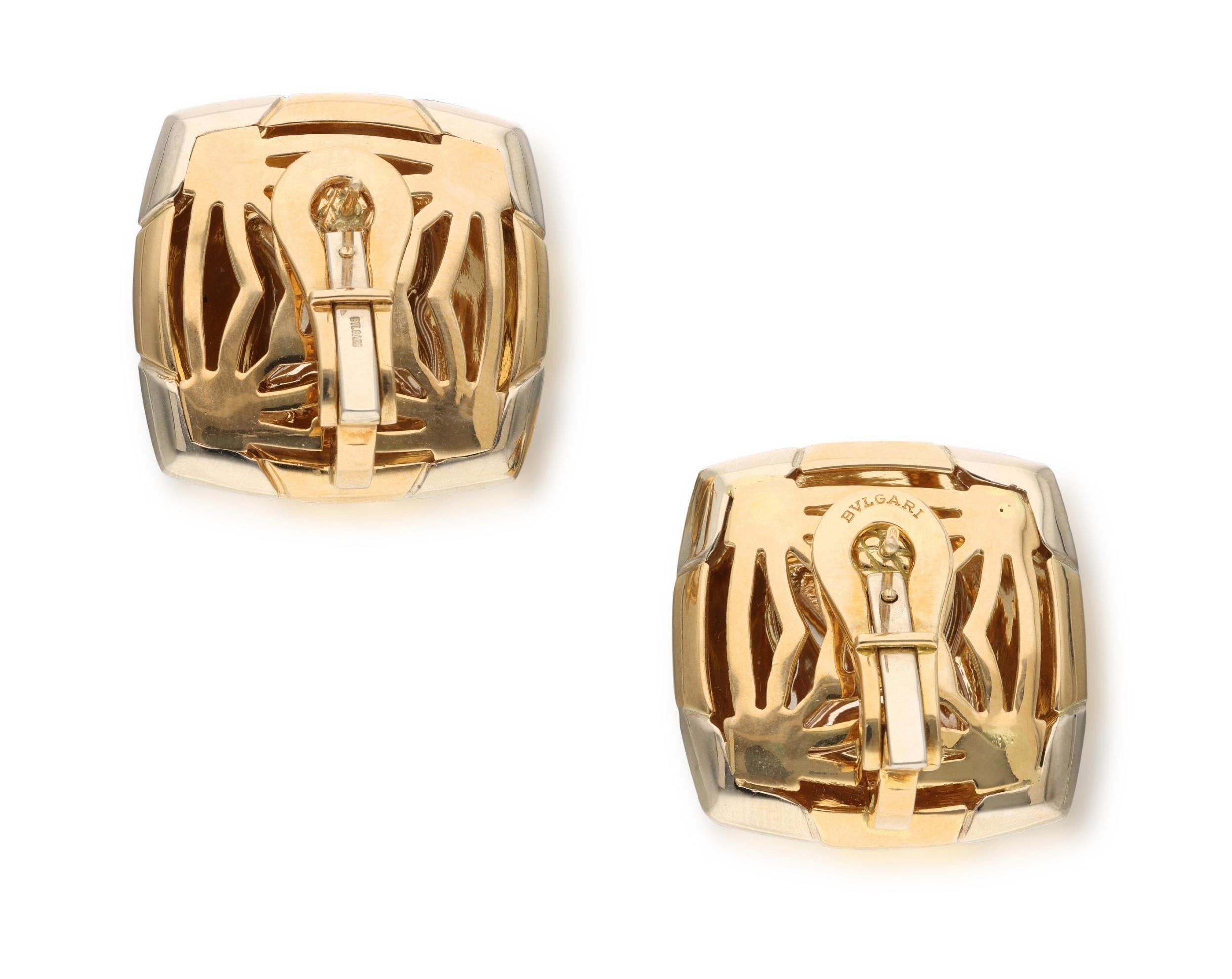 In the style of a pyramid, these ear clips are composed of two-tone gold.

- Signed Bvlgari
- Italy
- 18 karat yellow and white gold
- Total weight 24.65 grams
- Length 1 inch and width 1 inch
- Fitted with posts

The condition report is Very Good. 