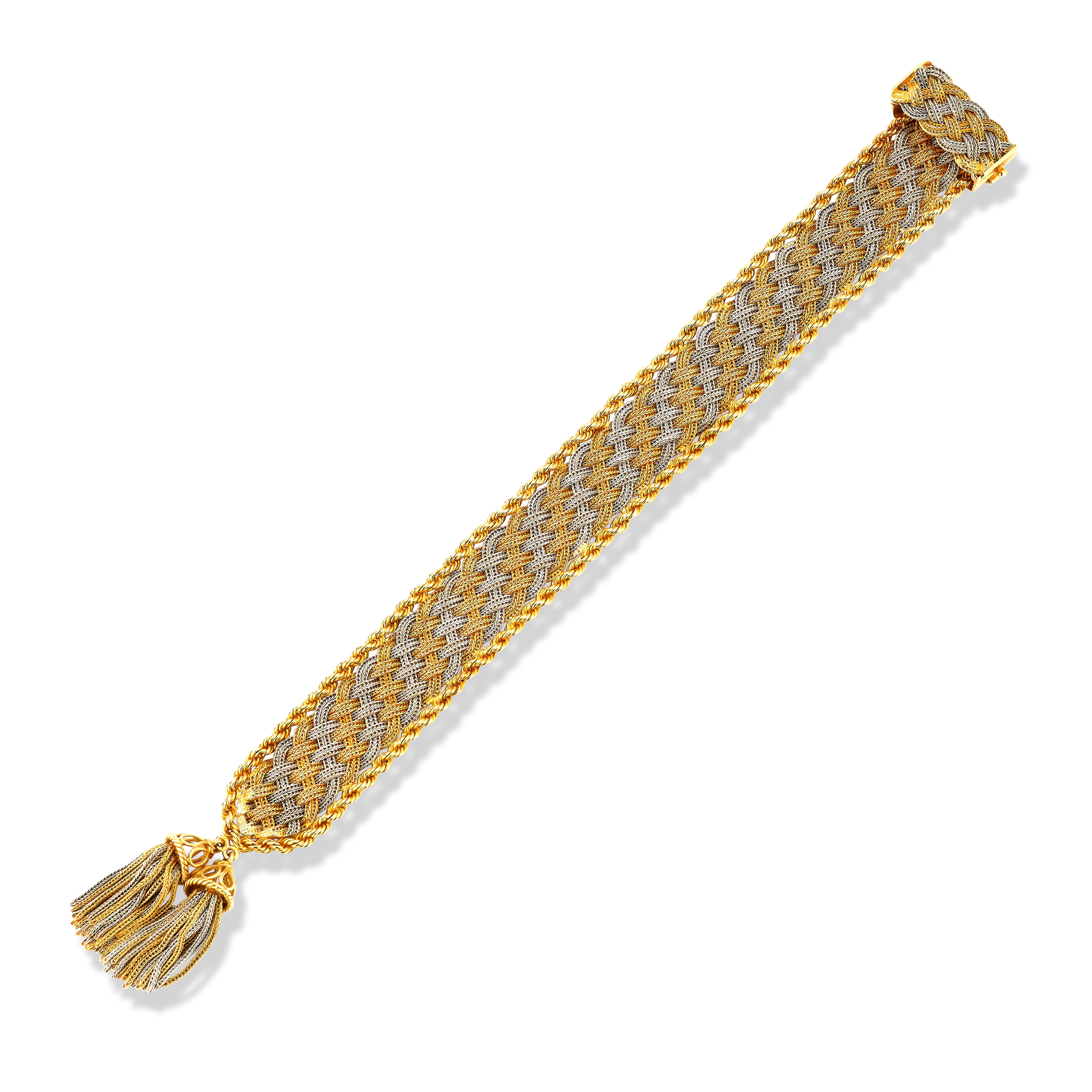 Bulgari Two Tone Gold Tassel Bracelet 

A two tone gold  bracelet with a wove rope motif pattern with two tassels elegantly draping from the side. 

***Length is adjustable***
Measurements:  bracelet, 8.75