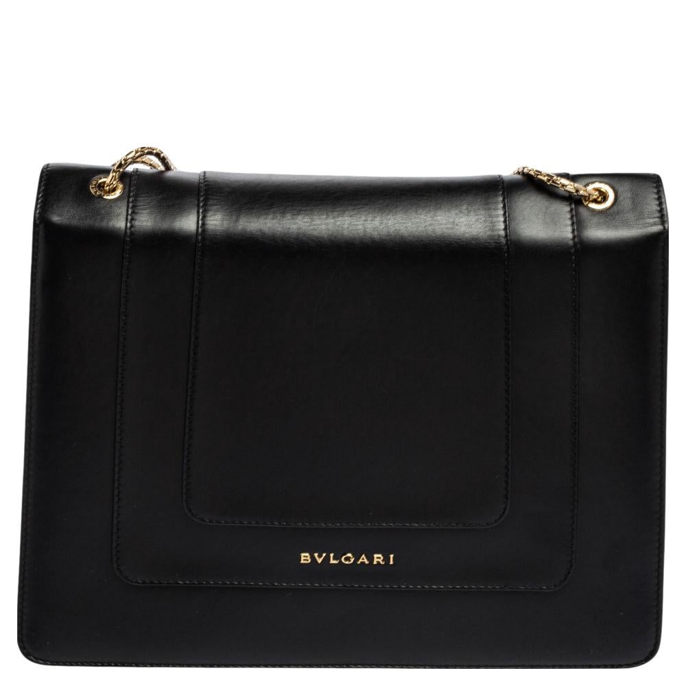 Dazzle the eyes that fall on you when you swing this stunning Bvlgari creation. Crafted from leather in breathtaking hues, the shoulder bag is styled with a flap that has the iconic Serpenti head closure. The bag has a spacious fabric interior and a