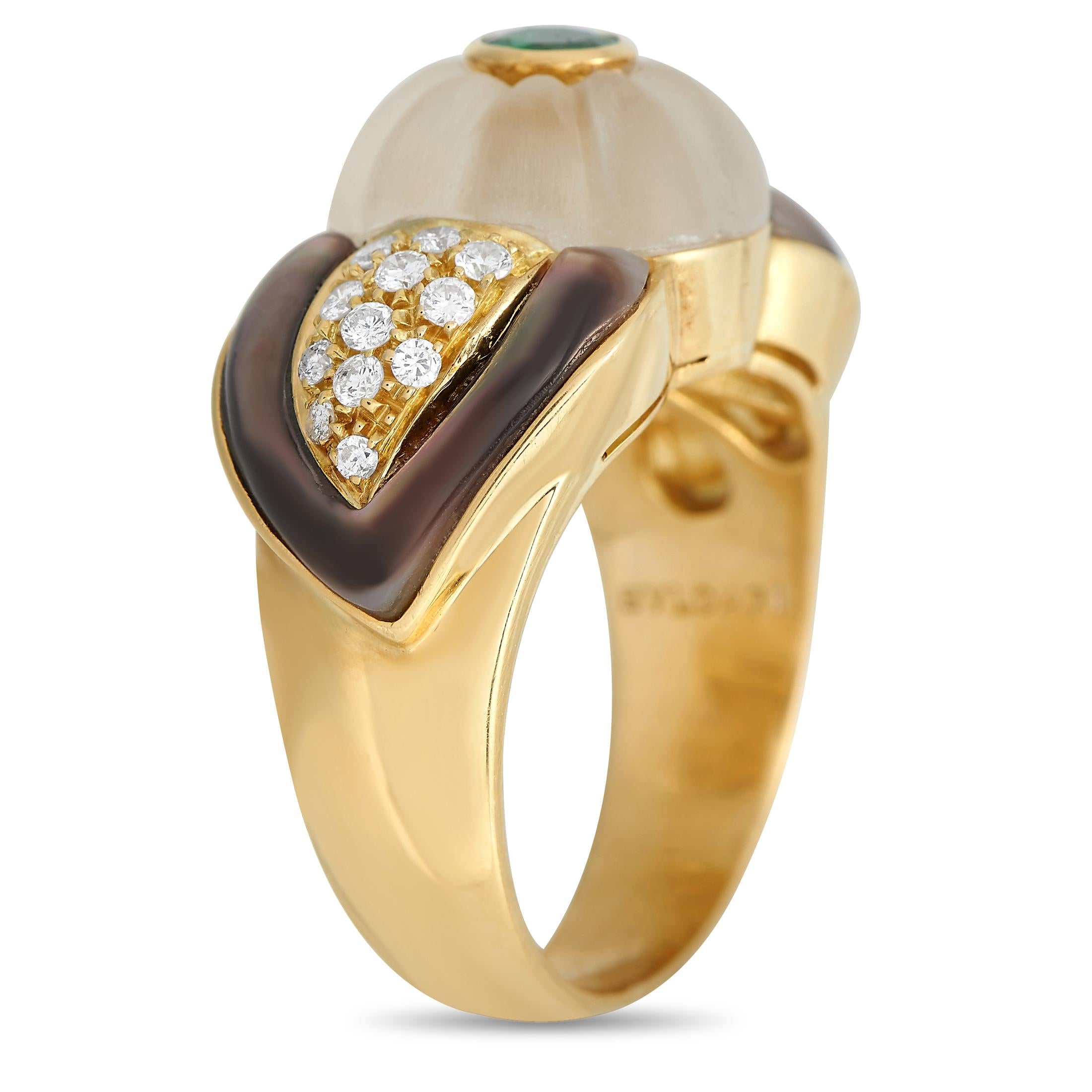 Accessorizing with this ring is an easy way to add a bold twist to your looks. This lovely Bvlgari piece features a wide and smooth yellow gold shank with a domed rock crystal center topped with a medium-green round-cut emerald gemstone. The