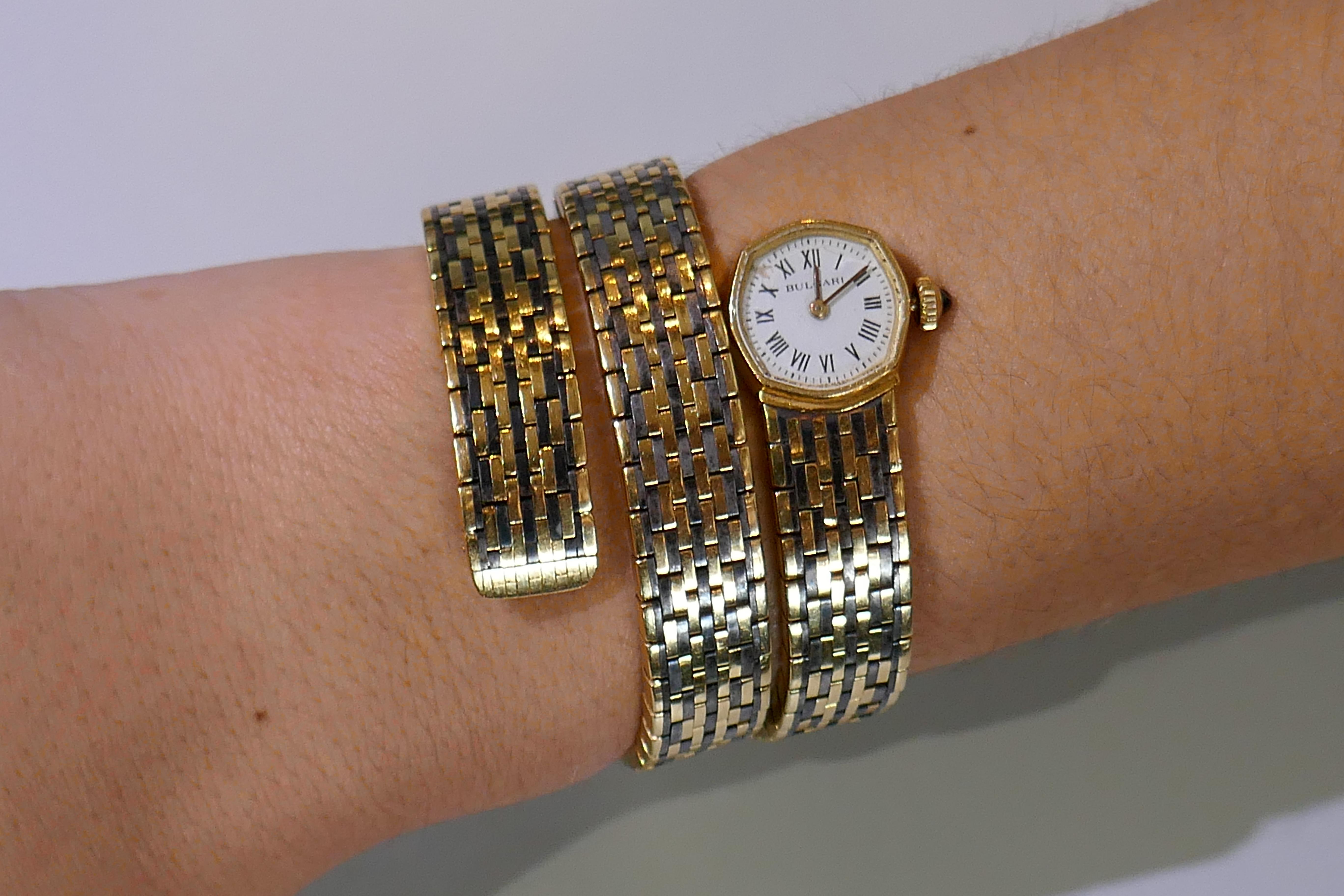 Iconic Bvlgari wrap bracelet watch created in Italy in the 1970s. 
Made of 18 karat yellow gold and hematite.
Fits up to 6-inch (15-centimeters) wrist.
Weight is 105.3 grams.
Stamped with Bulgari maker's mark and serial number.
