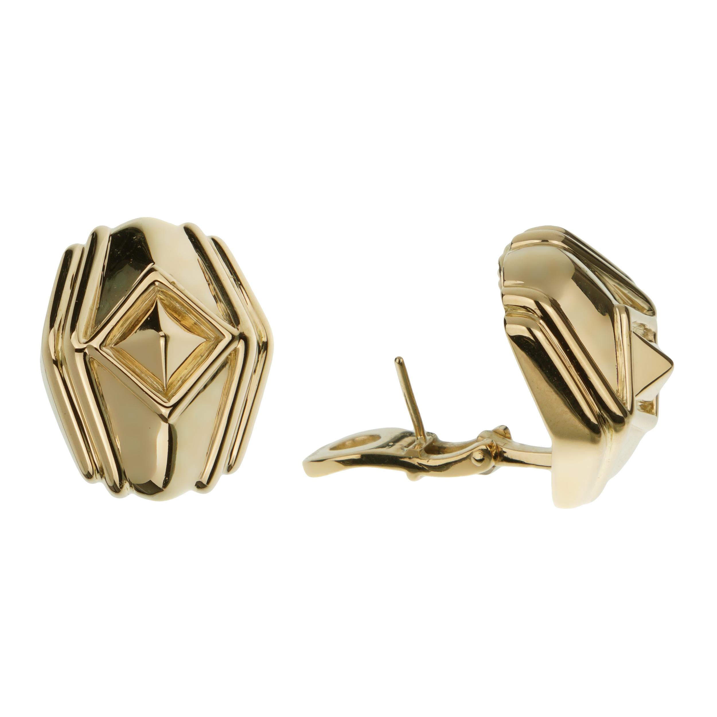 These earrings feature a unique, bold geometric design that is both striking and elegant. The overall shape of the earrings is a rounded polygon, with soft, curvaceous lines that give them a distinct, sculptural quality. This design is enhanced by