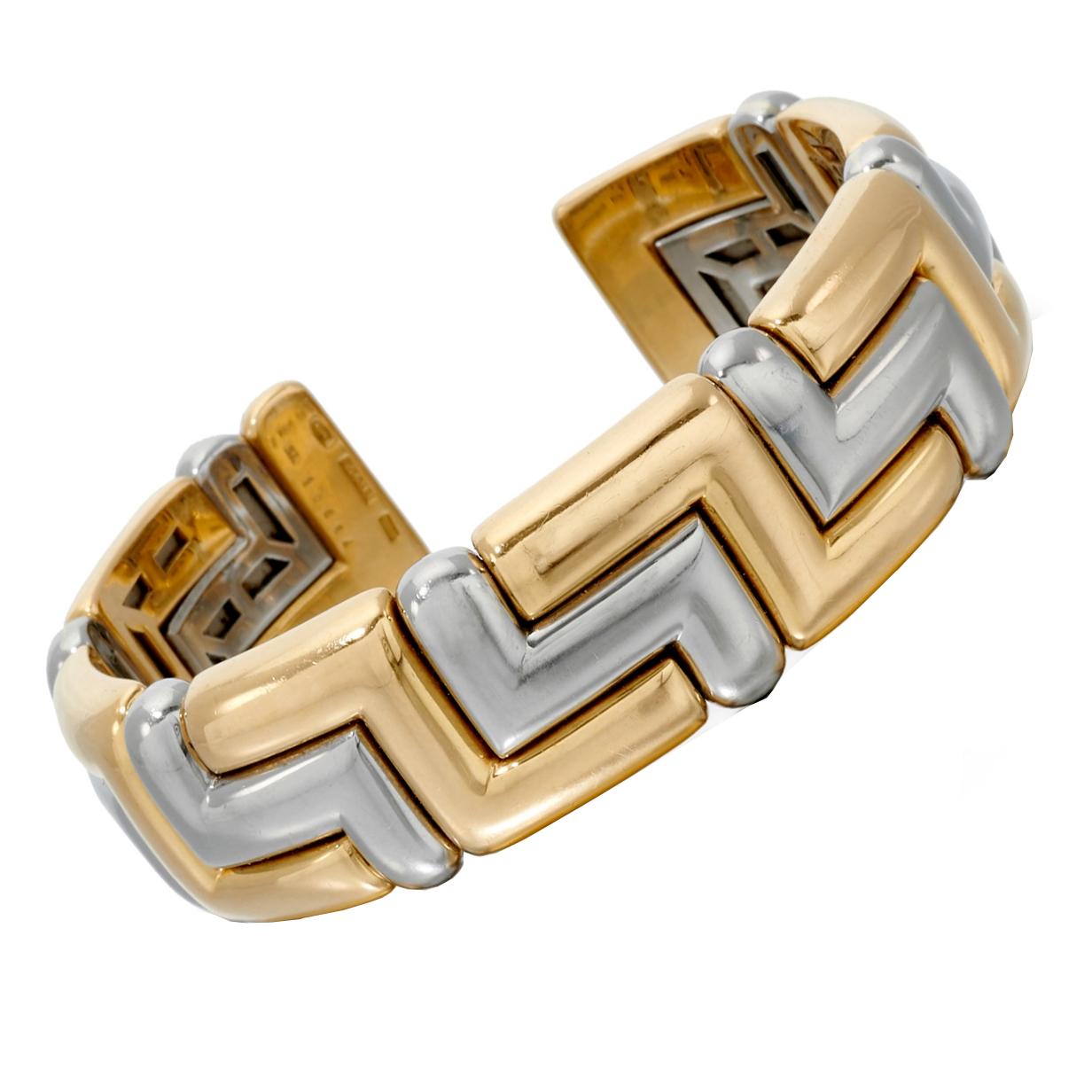 A must have vintage Bvlgari cuff bangle bracelet showcasing white and yellow gold in a geometric motif. The internal opening is roughly 6.5