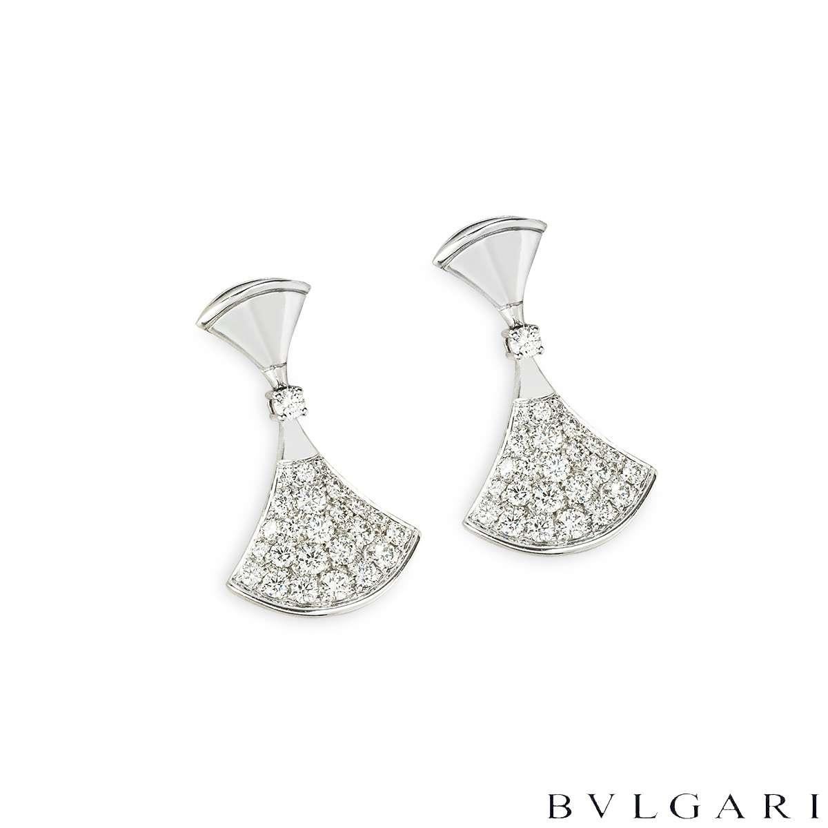 An elegant pair of 18k white gold diamond earrings by Bvlgari from the Divas' Dream collection.  Each of the earrings is set with a single round brilliant cut diamond followed by a fan-shaped motif pave set with 22 round brilliant cut diamonds.The