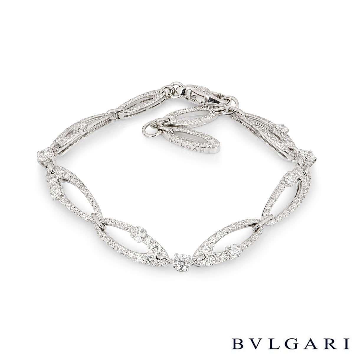 An 18k white gold diamond Elisia bracelet by Bvlgari. The bracelet is made up of 9 oval shaped links, each pave set with round brilliant cut diamonds. There are 9 claw set larger round brilliant cut diamonds scattered throughout the bracelet. The